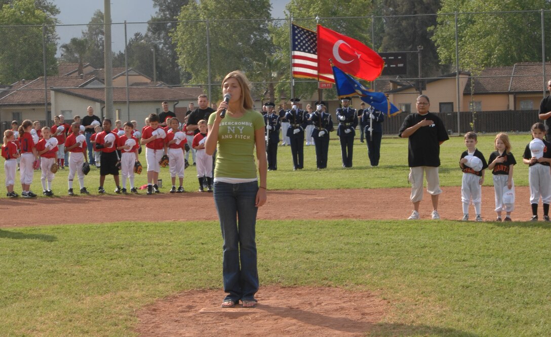 Madison Hall, daughter of Lt. Col. Dwayne Hall, 39th Air Base Wing command post, sings the National Anthem at the Little League opening day ceremony at Incirlik Air Base, Turkey, Saturday, April 25, 2009. Seventeen teams of children ranging from ages 5-14 years old participate in little league season. The Lil Divas cheerleaders ages 5-8 and the Indianapolis Colts Cheerleaders also performed at the opening ceremony. (U.S. Air Force photo/Staff Sgt. Lauren Padden)