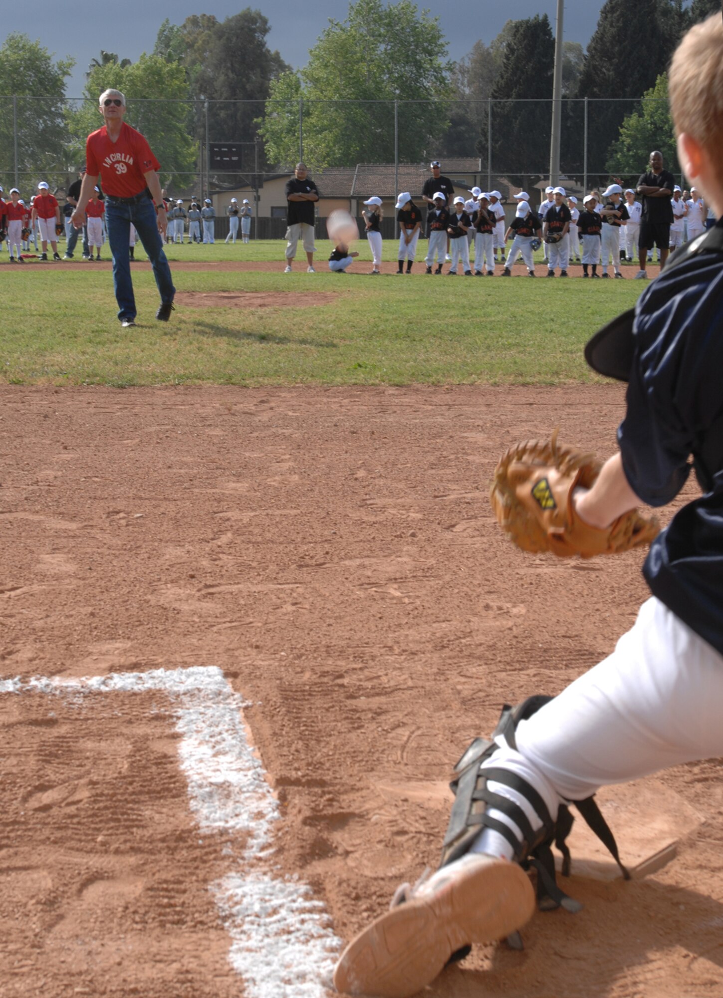 Col. Philip McDaniel, 39th Air Base Wing commander, throws the first pitch of the season at the Little League opening day to Michael Pelkey, 13, Braves catcher and son of Maj. Kyle Pelkey, 39th Medical Operations Squadron at Incirlik Air Base, Turkey, Saturday, April 25, 2009. Seventeen teams of children ranging from ages 5-14 participate in little league. (U.S. Air Force photo/Staff Sgt. Lauren Padden)