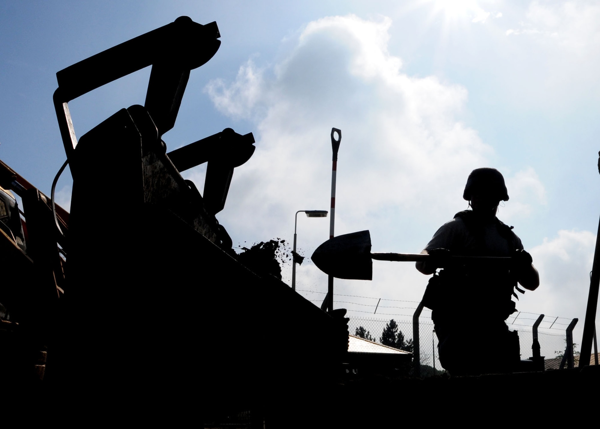 Airman 1st Class Richard Moore, 100th Civil Engineer Squadron liquid fuels journeyman, shovels dirt from a plant box during a deconstruction project April 28, 2009, at RAF Mildenhall, England. Normally contracted out, this project only involved Airman from the 100th CES to remove plant boxes and repave the area to make it more appealing. According to Master Sgt. Joseph Lamberti, this move was to boost unity and morale while also saving the Air Force thousands of dollars in the process. (U.S. Air Force photo by Staff Sgt. Jerry Fleshman)