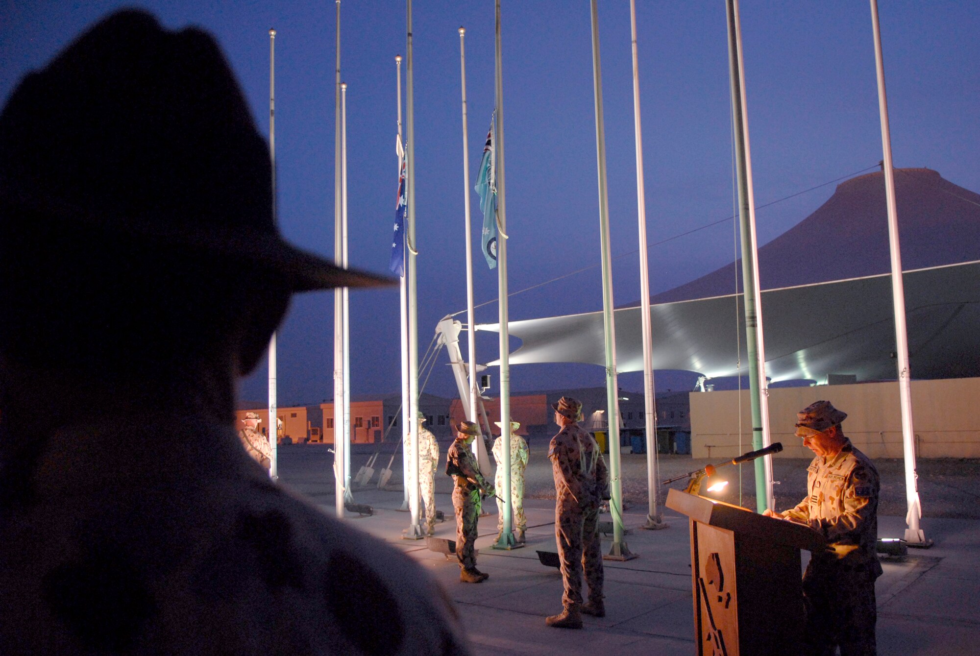 Wing Commander Robert Drinkwater, Commander Task Group 633.2.1, addresses the audience during the Australia and New Zealand Army Corps (ANZAC) Day ceremony, Apr. 25, 2009, at an undisclosed location in Southwest Asia.  ANZAC Day is a national day of remembrance in Australia and New Zealand to honor the members of ANZAC who fought at Gallipoli in World War I and more broadly commemorates all those who have died and served in military operations for the country.  The military members who attended the event are deployed in support of Operations Iraqi and Enduring Freedom and Combined Joint Task Force - Horn of Africa.  (U.S. Air Force photo/Senior Airman Andrew Satran/released)
