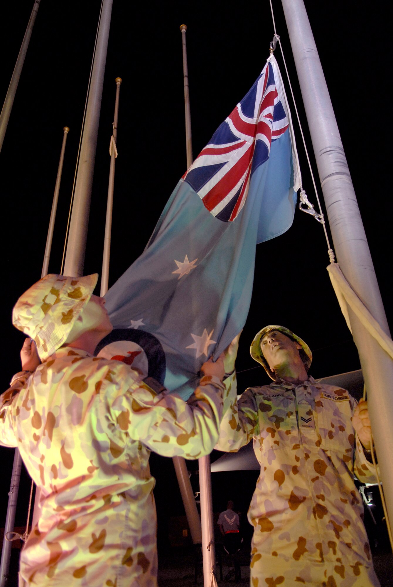Royal Australian Air Force (RAAF) Lead Aircraftsman Mitchell Philpot and Corporal Steve Clarke, TE 633.2.2.1, raise the RAAF Ensign in honor of Australia and New Zealand Army Corps (ANZAC) Day, April 25, 2009, at an undisclosed location in Southwest Asia.  ANZAC Day is a national day of remembrance in Australia and New Zealand to honor the members of ANZAC who fought at Gallipoli in World War I and more broadly commemorates all those who have died and served in military operations for the country.  Cpl. Clarke hails from Brisbane, Australia and is deployed from Amberley base, Australia.  LAC Philpot hails from Sydney, Australia and is deployed from Richmond, Australia.  Both are deployed in support of Operations Iraqi and Enduring Freedom and Combined Joint Task Force - Horn of Africa.  (U.S. Air Force photo/Senior Airman Andrew Satran/released)  
