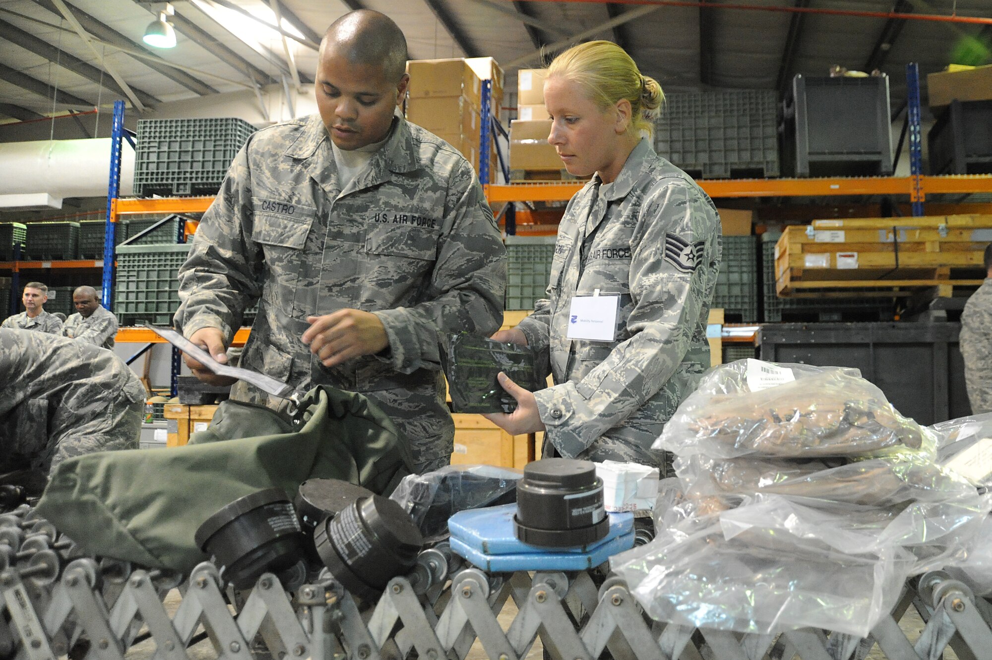 Staff Sgt. Angela Dawson, 380th Expeditionary Logistics Readiness Squadron, assists Airman 1st Class Eric Castro, 380th ELRS, inventory the contents of his C-bag during a readiness exercise, April 21 at undisclosed location in Southwest Asia. The 380th ELRS ran the exercise to test the timeliness and capability for redeployment of Airmen. Sergeant Dawson is deployed from Eglin AFB, Fla. and hails from Tallahassee, Fla. Airman Castro is deployed from Eglin AFB, Fla. and is from Rochester, N.Y. (U.S. Air Force photo by Senior Airman Brian J. Ellis) (Released)