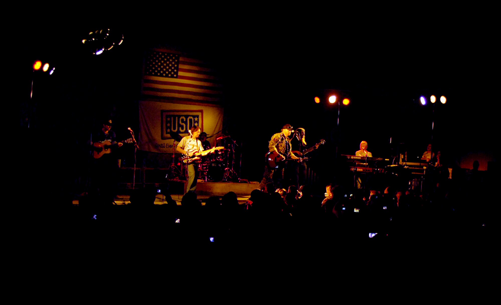 More than 1,000 service members cheer for country music singer, Toby Keith, during his United Service Organizations tour at Bagram Air Field, Afghanistan April 27.  To support troops participating in Operations Enduring and Iraqi Freedom, USO centers opened in Afghanistan, Kuwait and Qatar. USO centers number 132 around the world. The USO provides a variety of programs and services, including orientation programs, family events, travel assistance, free Internet and e-mail access, and recreation services. USO entertainment tours continue to boost troop morale and feature such celebrities as Robin Williams, Wayne Newton, Ben Affleck, Gary Sinise, Jessica Simpson, Charles Barkley, John Elway, Drew Carey and Toby Keith. (U.S. Air Force photo/Senior Airman Steven R. Doty)(Released)