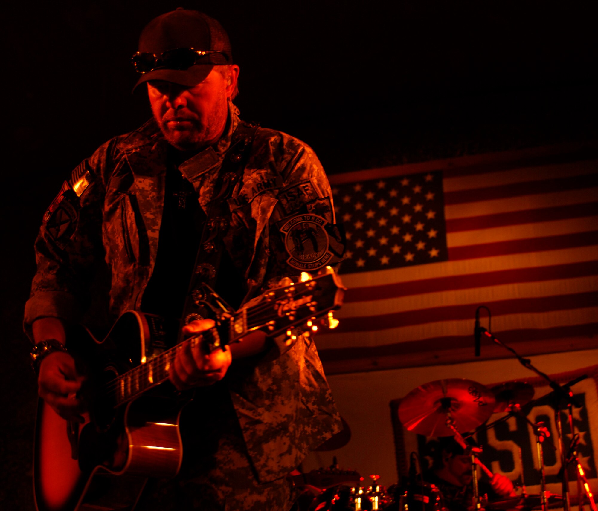 Country singer Toby Keith plays for more than 1,000 service members at Bagram Air Field, April 27.  This was Keith?s last show of 15 in Afghanistan, during his seventh tour with the United Service Organizations. Since 2002, Keith and company have visited war zones, military bases and ships at sea to bring a little levity and light into the lives of those in harm?s way. (U.S. Air Force photo/ Senior Airman Erik Cardenas)(Released)
