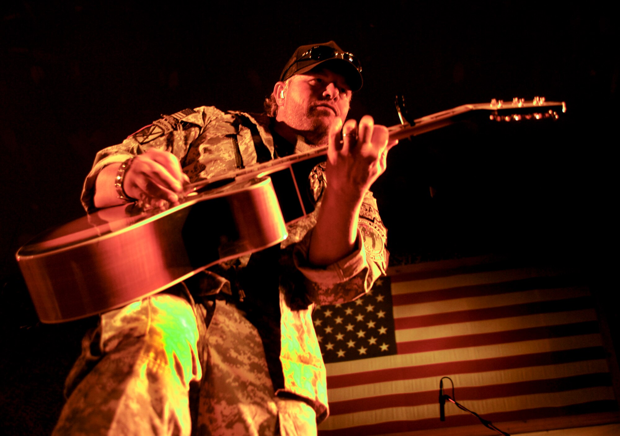 Country singer Toby Keith plays for more than 1,000 service members at Bagram Air Field, April 27.  This was Keith?s last show of 15 in Afghanistan, during his seventh tour with the United Service Organizations. Since 2002, Keith and company have visited war zones, military bases and ships at sea to bring a little levity and light into the lives of those in harm?s way. (U.S. Air Force photo/ Senior Airman Erik Cardenas)(Released)