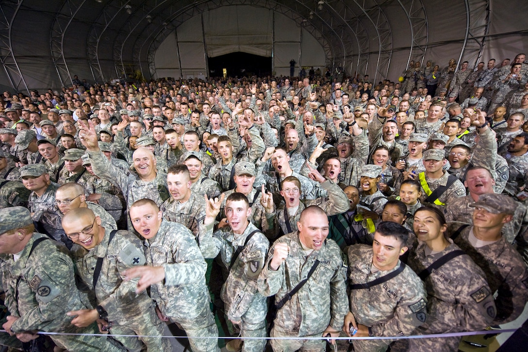 During his seventh tour to visit deployed troops, Toby Keith and Scotty Emerick put on two shows each day at the smaller, more remote bases FOBs & COPs. Then each night the full band would do a larger show at the closer of the large bases such as here at FOB Sharana, where the audience eagerly awaits the show to begin. USO Courtesy photo by Dave Gatley