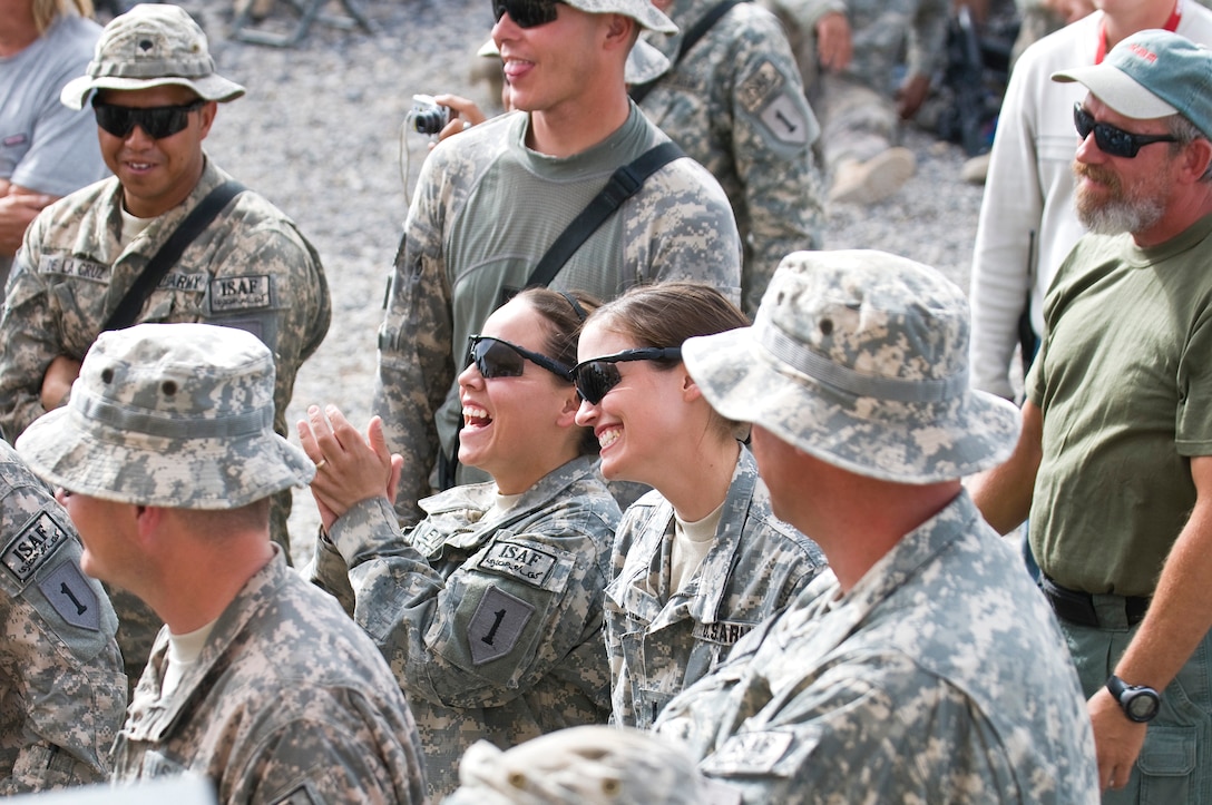 Troops at Combat Outpost Ramrod in Afghanistan watch Toby Keith and his band perform. USO Courtesy photo by Dave Gatley