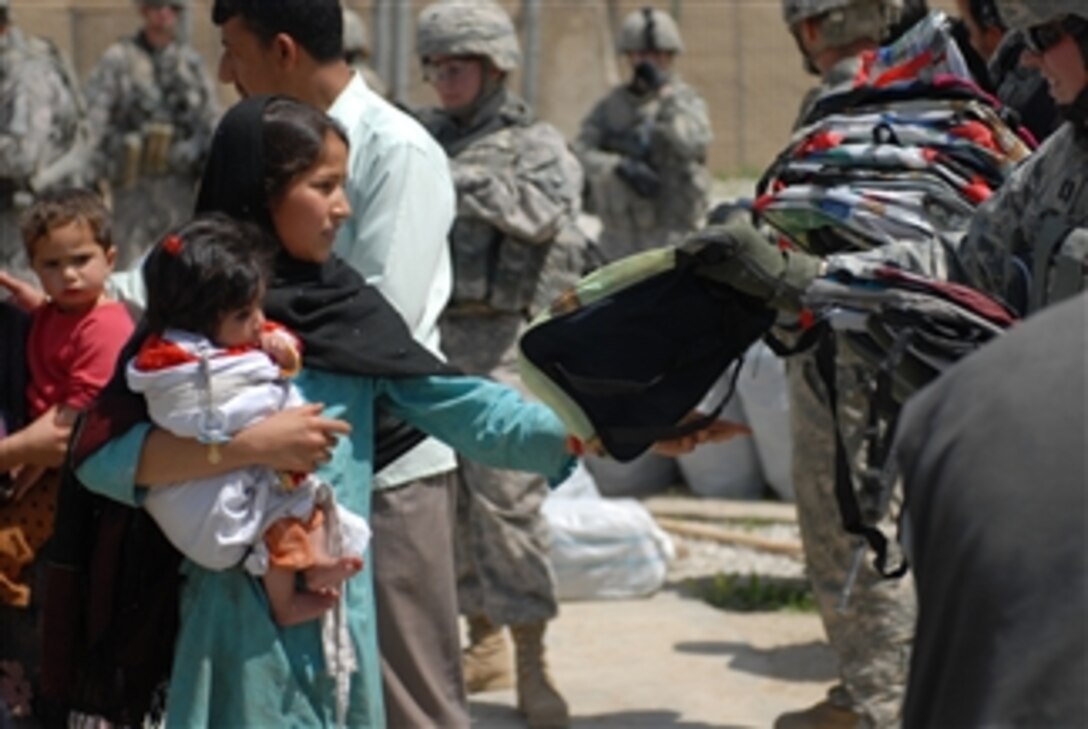 A student from the Janquadam Middle School in Janquadam Village, Afghanistan, receives a backpack from Task Force Warrior soldiers during a humanitarian aid mission on April 20, 2009.  Maps, paper, pencils, chalk and other teaching aids were given out to school workers while approximately 1,200 students received school packs, first aid supplies and hygiene kits.  