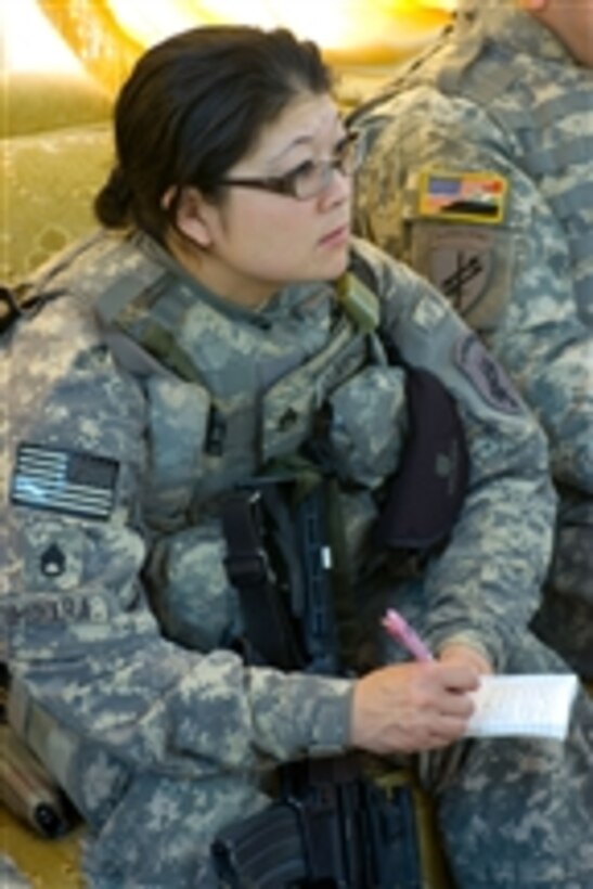 U.S. Army Staff Sgt. Kay Izumihara takes notes during a meeting in the village of Laylan in Kirkuk, Iraq, on April 26, 2009.  Izumihara is a member of the 490th Civil Affairs Company, 321st Civil Affairs Brigade, 353rd Civil Affairs Command, U.S. Army Civil Affairs and Psychological Operations Command.  