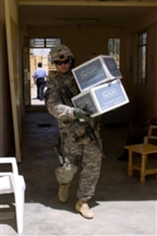 U.S. Army Staff Sgt. Daniel Heptins unloads boxes of school books in Kirkuk, Iraq, on April 26, 2009.  Heptins is attached to 3rd Platoon, Crazy Horse Troop, 4th Squadron, 9th Cavalry Regiment, 2nd Heavy Brigade Combat Team, 1st Cavalry Division.  