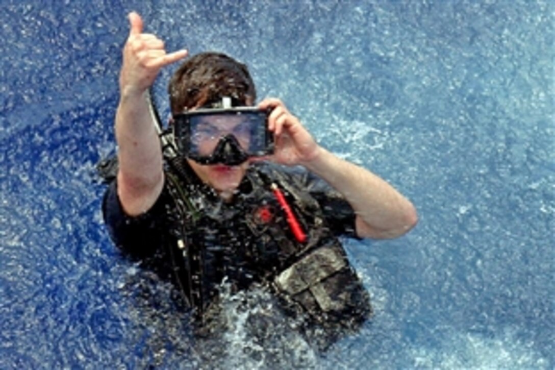 U.S. Navy Petty Officer 3rd Class Owens signals that he has landed safely in the water during the search and rescue portion of Exercise UNITAS Gold in the Atlantic Ocean, April 27, 2009. Maritime forces from the U.S., Brazil, Canada, Chile, Colombia, Ecuador, Germany, Mexico, Peru, and Uruguay are participating in the exercise, which provides the opportunity to conduct and integrate joint and combined land, maritime, coast guard and air operations in a realistic training environment.