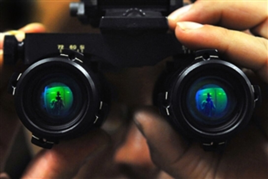 U.S. Navy Petty Officer 2nd Class Joseph Villarreal inspects a pair of night vision goggles for scratches on the lenses and to ensure it has free movements during Red Flag-Alaska on Eielson Air Force Base, Alaska, April 23, 2009. Villarreal is an aviation life-support equipment technician assigned to the Naval Air Station Whidbey Island, Wash.
