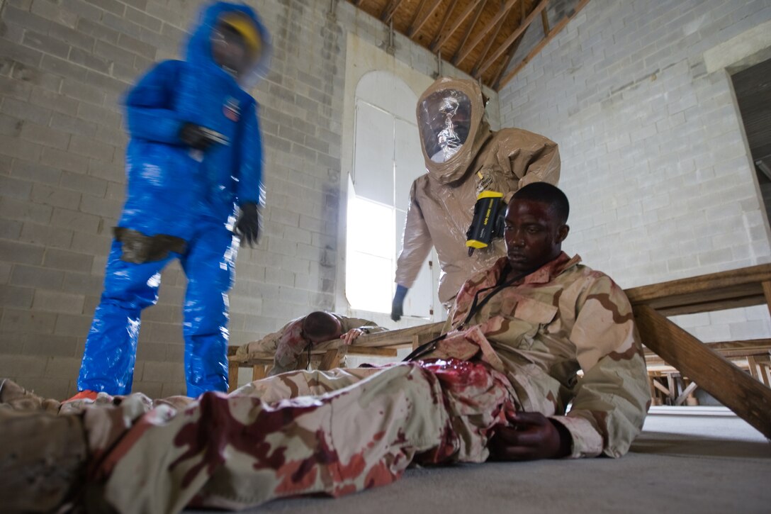 During a staged memorial service for a fallen Marine, at the Military Operations on Urban Terrain facility on Camp Lejeune, emergency response personnel evaluate injured Marines following a simulated chemical attack as a part of the full-scale antiterrorism exercise ‘Urgent Response 2009’ held on Camp Lejeune and Marine Corps Air Station New River, April 30.