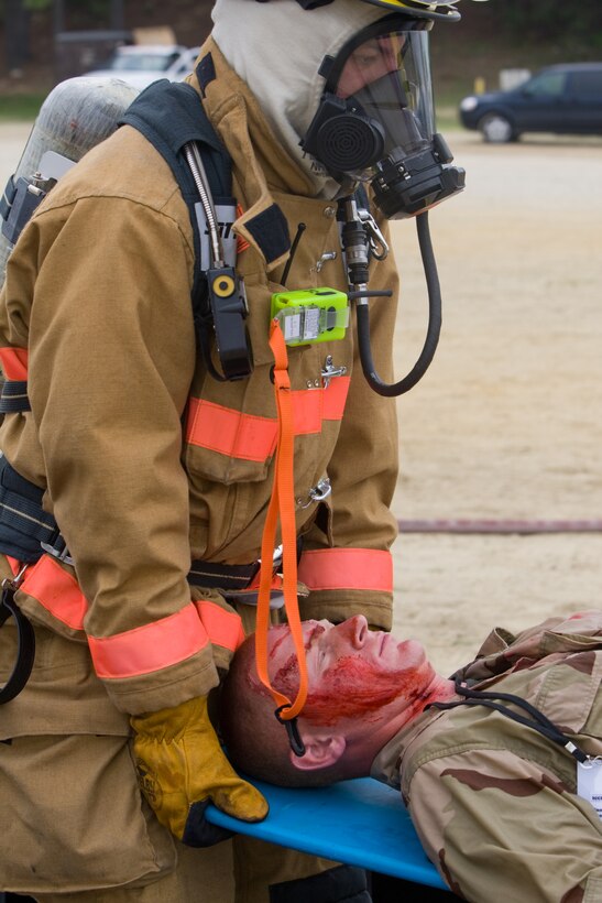 Pfc. Jermiah Gallagher, a student with the Marine Corps Engineer School, is carried by a Camp Lejeune Fire and Emergency Services responders following a simulated chemical attack during the full-scale antiterrorism exercise ‘Urgent Response 2009’ held on Camp Lejeune and Marine Corps Air Station New River, April 30.