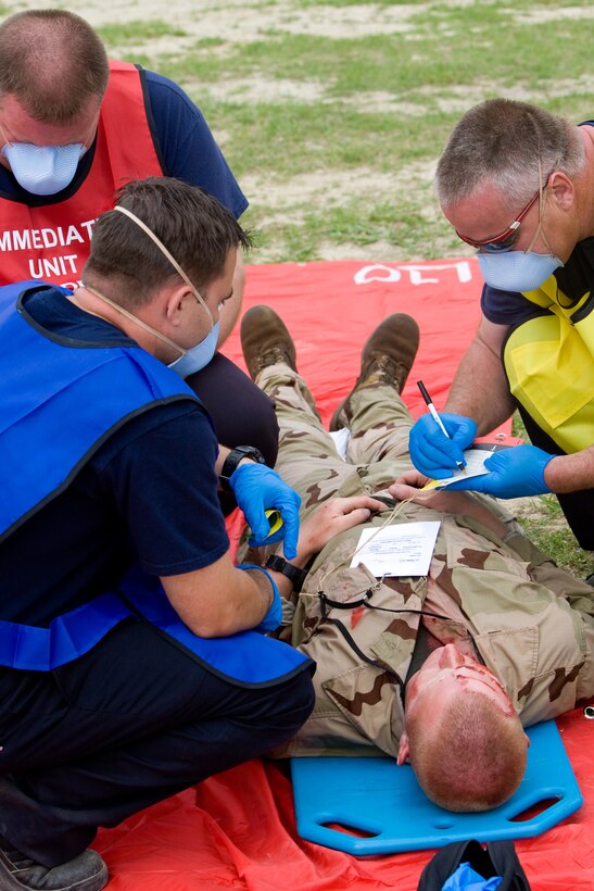 Pfc. Jermiah Gallagher, a student with the Marine Corps Engineer School, is treated for simulted chemical injuries during the full-scale antiterrorism exercise ‘Urgent Response 2009’ held on Camp Lejeune and Marine Corps Air Station New River, April 30.