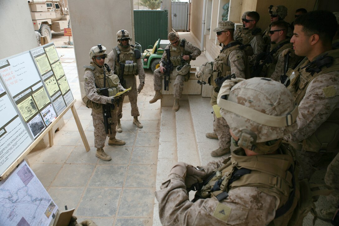 Sergeant Juan Valdez, a vehicle commander with Mobile Security Detachment, Headquarters Company, Regimental Combat Team 8, gives a patrol brief to his section while acting as patrol leader.  Valdez sustained wounds in combat during his last deployment, and not unlike fellow wounded service members, has felt personal guilt for having to leave his fellow Marines during that time.