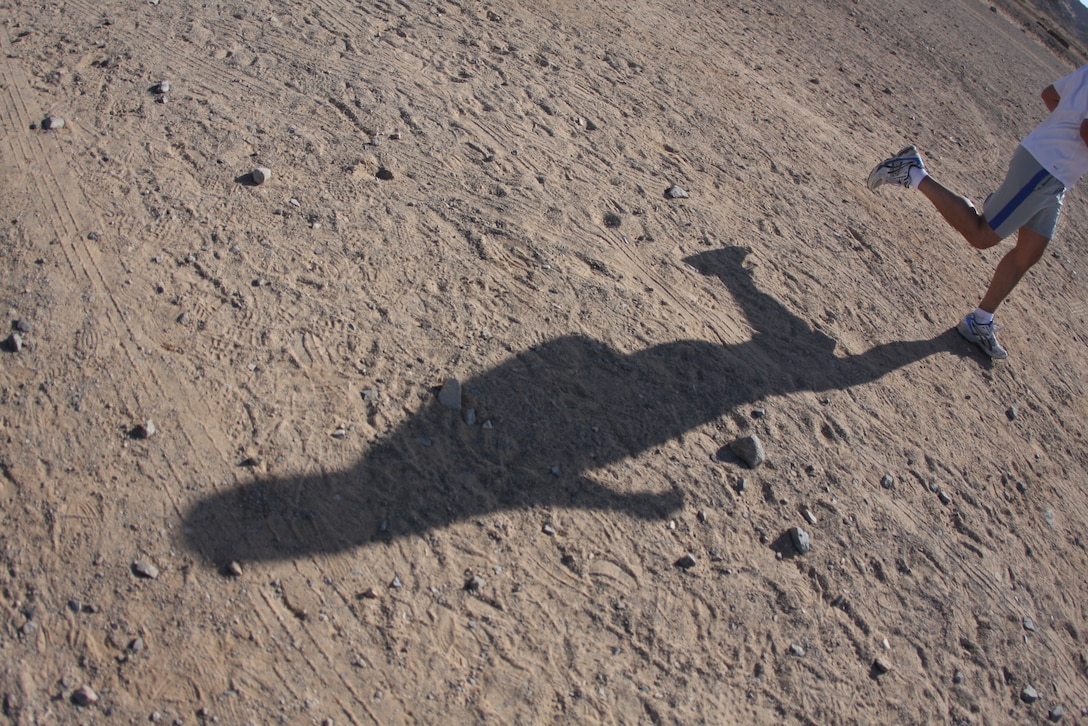 A runner sprints across the sand towards the finish of the eight kilometer (4.97 mile) race through the hills behind the Combat Center’s main side during the 23rd annual ridge run April 30.