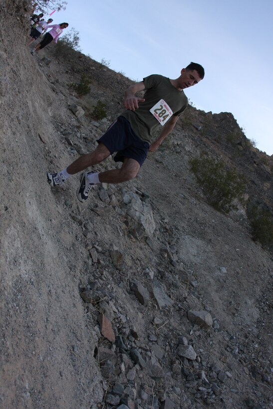 A runner during the 23rd annual ridge run makes his way down one of the dangerous hills located behind the Combat Center’s main side April 30.