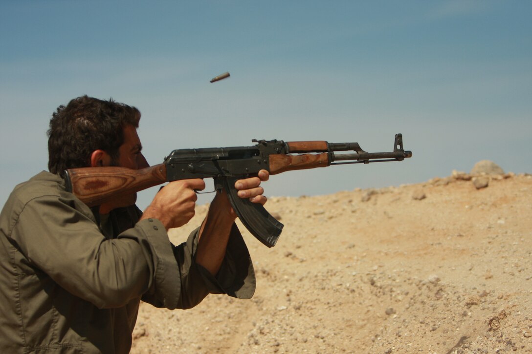 David Fakhoury, a role player with the Advisor Training Group, opens fire on a patrol of Marine Corps and Iraqi role player vehicles May 1 at the Combat Center’s Gypsum Ridge training area.
