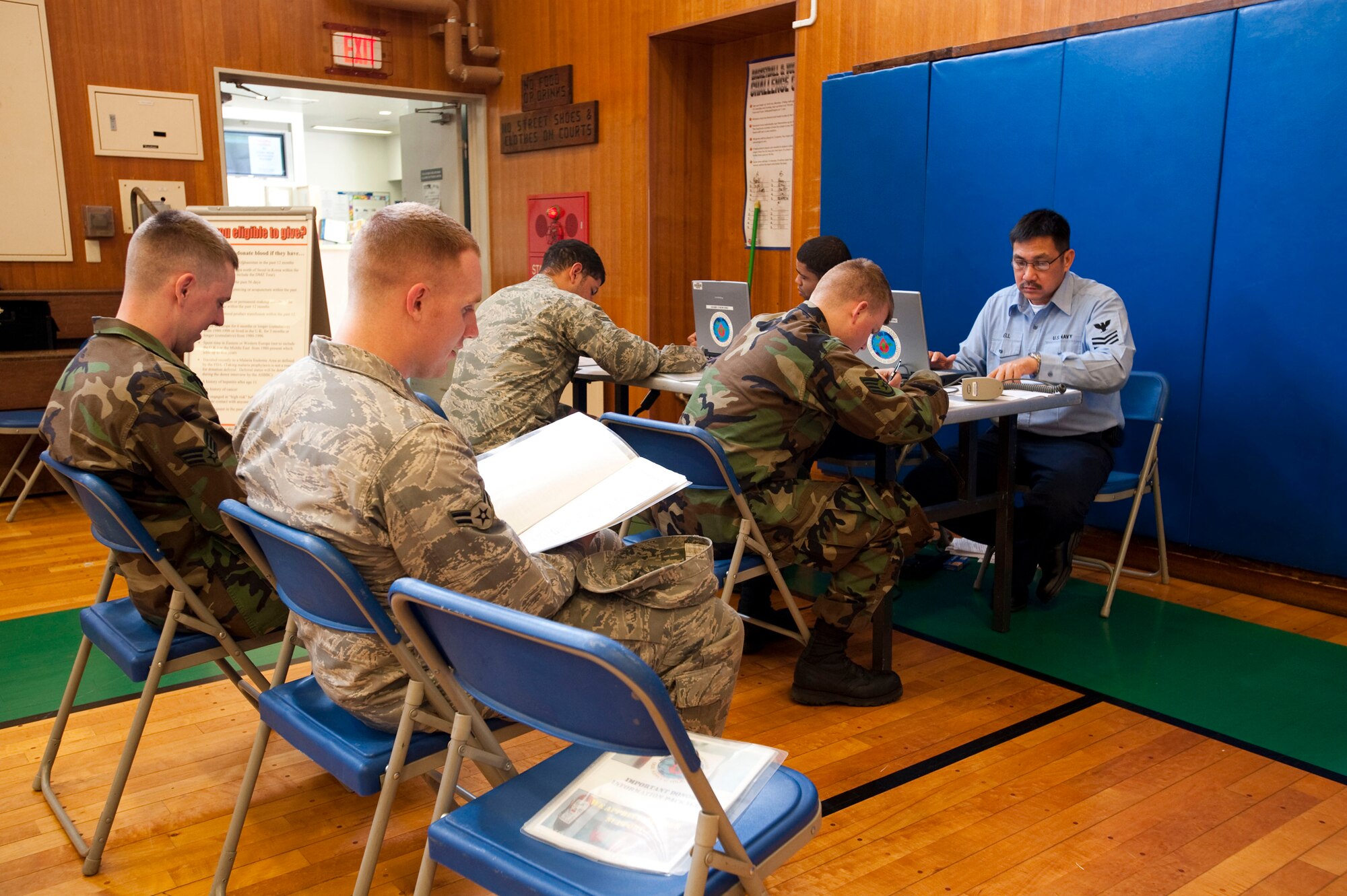 MISAWA AIR BASE, Japan -- Airmen wait to register to give blood at the Potter Fitness Center April 28, 2009. Potential donors were screened first to make sure they are eligible to donate. A sign near the door helped inform donors of what would disqualify them. (U.S. Air Force photo by Staff Sgt. Samuel Morse)