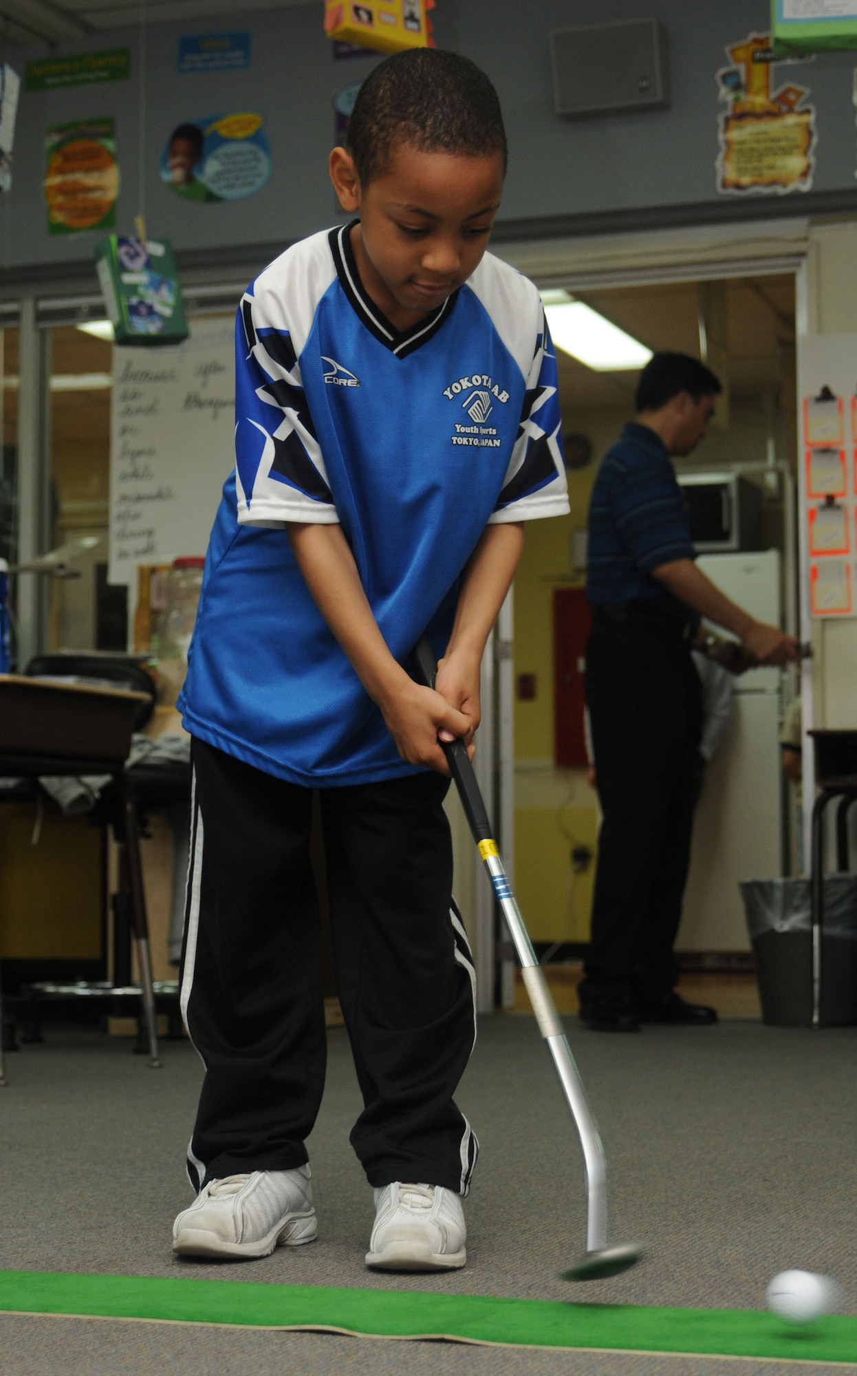 YOKOTA AIR BASE, Japan -- Jaylen Johnson putts a ball April 30 during the Family Fit Picnic at Yokota West Elementary School. The picnic, which included fit activities such as Zumba, yoga, aerobics and other games, was the final event to celebrate April as the Month of the Military Child. (U.S. Air Force photo/Airman Sean Martin)
