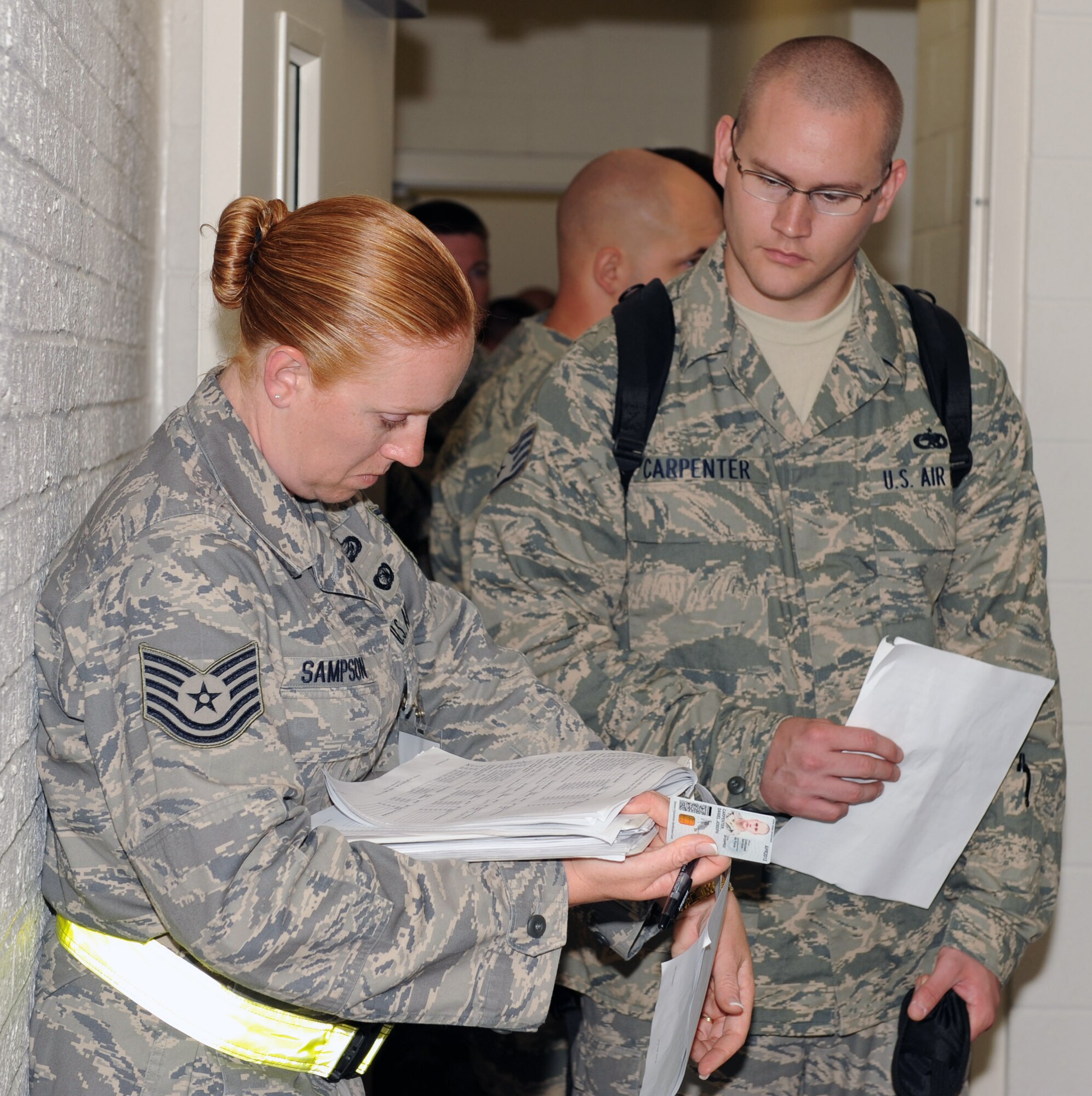 Staff Sgt. Daniel Carpenter, 4th Equipment Maintenance Squadron, checks in with Tech. Sgt. Linda Sampson, 4th Force Support Squadron, in the personnel deployment facility at Seymour Johnson Air Force Base, N.C., April 29. Sergeant Carpenter is deploying to Bagram Airfield, Afghanistan, for approximately four months. (U.S. Air Force photo/Airman 1st Class Gino Reyes)