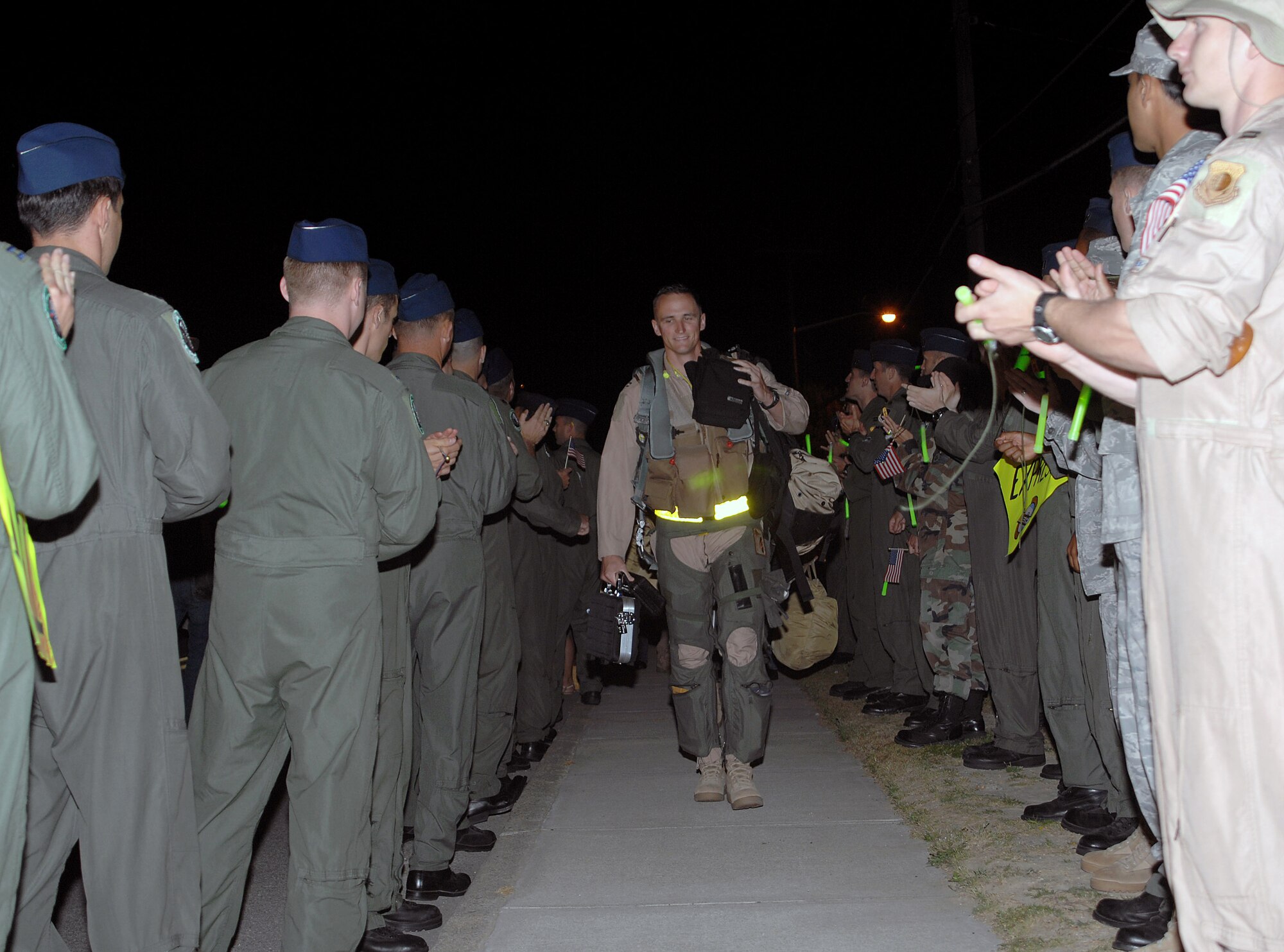 Capt. David Gunter, 336th Fighter Squadron aircrew, strides through a gauntlet of well wishers before stepping to an awaiting F-15E Strike Eagle at Seymour Johnson Air Force Base, N.C., April 29.  More than a dozen fighter aircraft were sent to Afghanistan provide air support to coalition ground forces.  (U.S. Air Force photo/2nd Lt. Matthew D. Schroff)