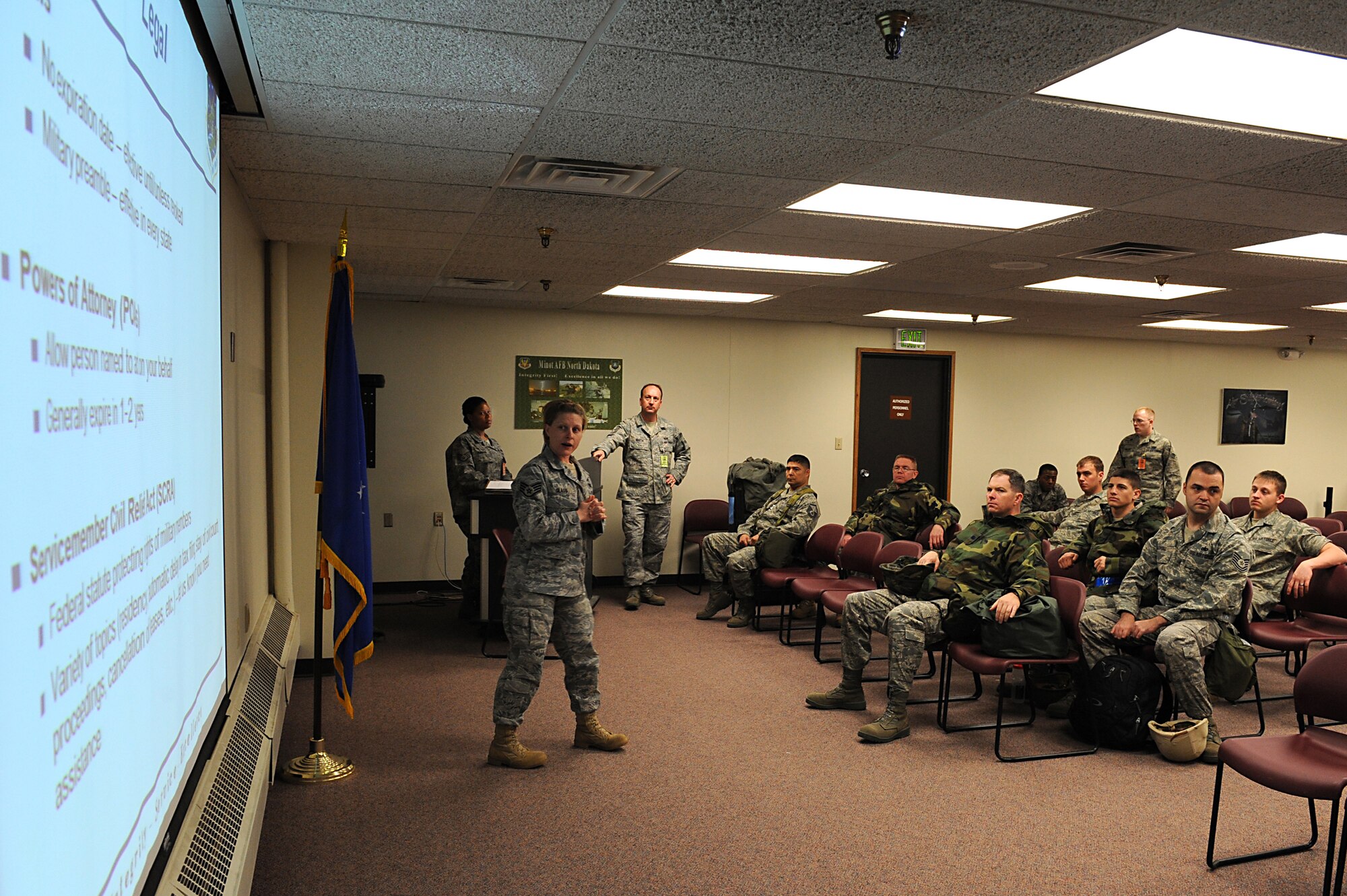 MINOT AIR FORCE BASE, N.D. -- Staff Sgt Casey Glass, a 5th Bomb Wing Paralegal, briefs Airmen simulating to deploy at a deployment processing line at Minot Air Force Base, April 24. The processing line was in support of Prairie Vigilance 09-7, which is a combined-wing exercise established to implement and assure safe, secure, reliable nuclear weapons standards and procedures. (U.S. Air Force photo by Senior Airman Kelly Timney)