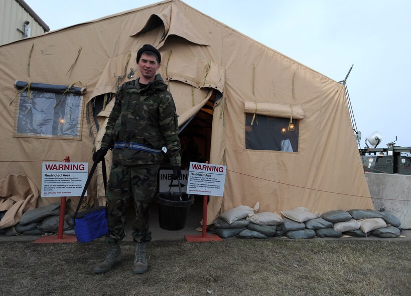 MINOT AIR FORCE BASE, N.D. -- Airman 1st Class Craig McNett, 5th Aircraft Maintenance Squadron crew chief, passes through an entry control point, April 24, after working a long day during Prairie Vigilance 09-7. Prairie Vigilance is a combined-wing exercise established to implement and assure safe, secure, reliable nuclear weapons standards and procedures.  (U.S. Air Force photo by Senior Airman Kelly Timney)