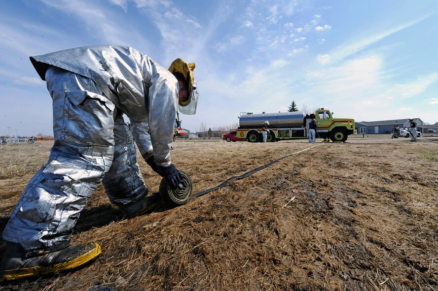 Firefighters from the 5th Civil Engineering Squadron pack up after fighting a live grass fire in base housing, near Minot Air Force Base’s North Planes Elementary School, April 24.  Despite most of North Dakota being under major flooding recently, residents in the ward county area are under a high fire risk and should remember that there is no open burning on Minot AFB. 2009 was a year that brought progress and a renewed emphasis on safe, secure and reliable nuclear operations. The 91st Missile Wing transitioned to Air Force Global Strike Command with the 5th Bomb Wing scheduled to follow suit in 2010. (U.S. Air Force photo by Senior Airman Kelly Timney)