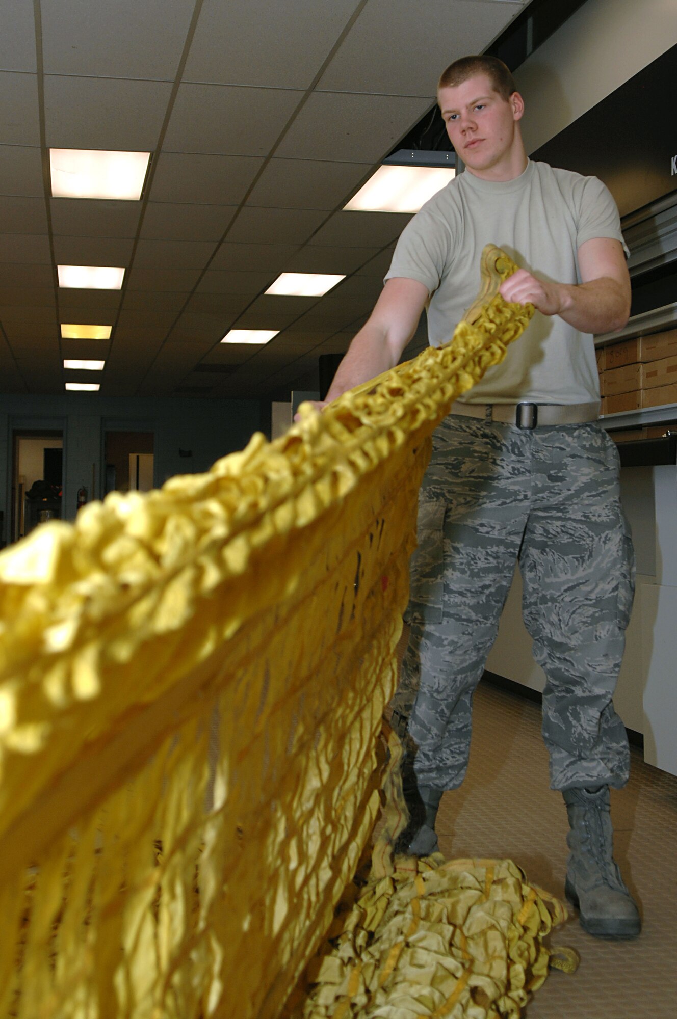 MINOT AIR FORCE BASE, N.D.- Airman 1st Class Cody Lytle, 5th Operations Support Squadron, Aircrew Flight Equipment Technician, prepares to pack a parachute here April 27. The 5 OSS inspected approximately 144 parachutes in support of exercise Prairie Vigilance 09-7. Prairie Vigilance is a combined-wing exercise established to implement and assure safe, secure, reliable nuclear weapons standards and procedures. (U.S. Air Force photo by Staff Sgt. Angel Gallardo)