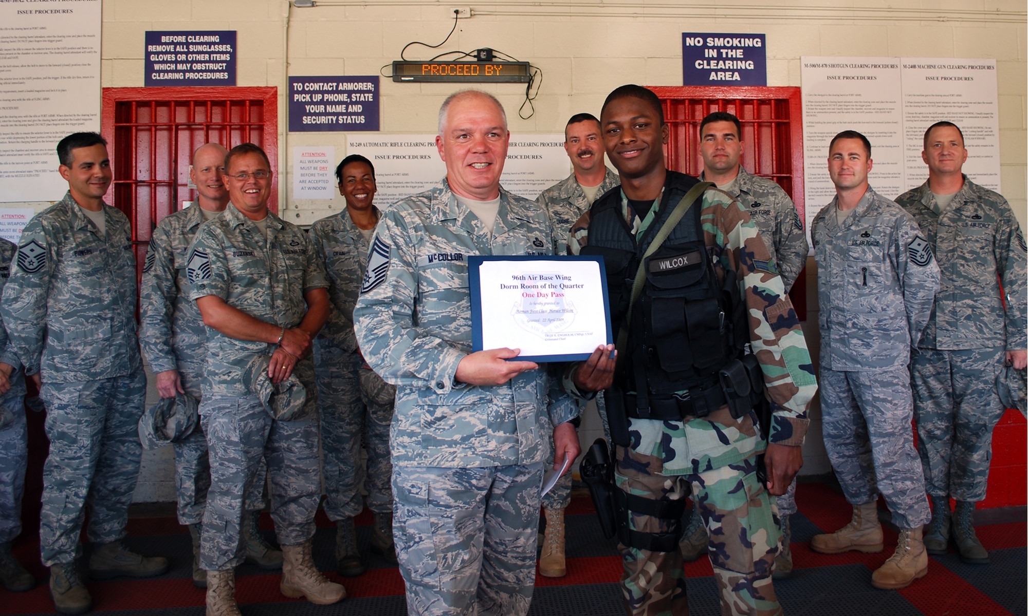 EGLIN AIR FORCE BASE, Fla. -- Airman 1st Class Horace Wilcox, 96th Security Forces Squadron, receives a certificate from Chief Master Sgt. Christopher McCollor, 96th Mission Support Group command chief, April 22, for going above and beyond hygienic standard of living and making his living quarters truly his. Dorm of the Quarter is a competition designed to recognize Airmen for their efforts to uphold these dorm room standards.