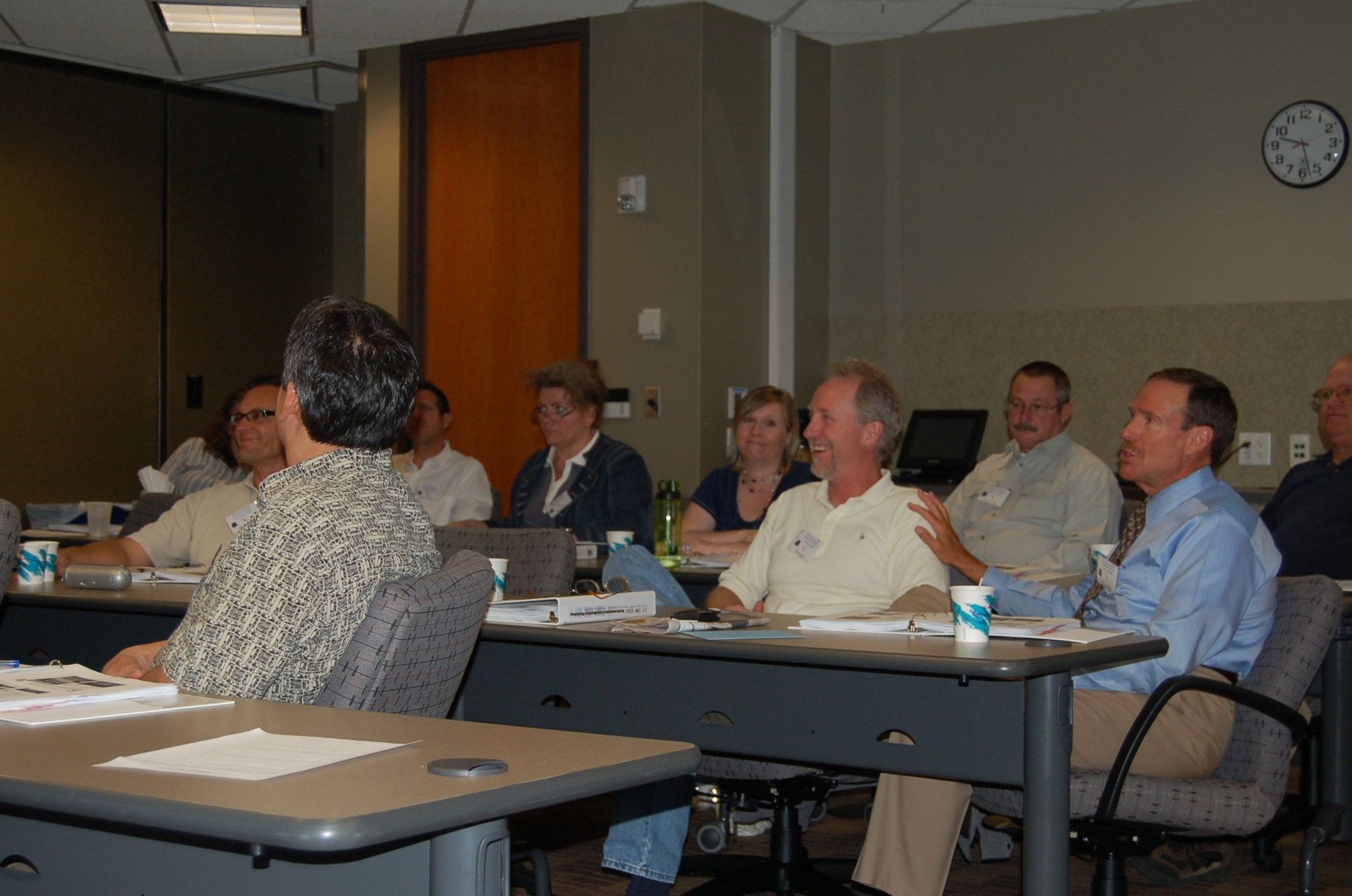 Environmental managers engage in dialogue at the 21st Space Wing Geographically Separated Unit Environmental Coordinator Workshop at the Plaza of the Rockies in Colorado Springs April 22. The workshop was held the week of Earth Day, and addressed risk management and cost-benefit under the new Civil Engineering Asset Management Flight. The new flight is part of an Air Force move to merge together corporate and military practices to create transparency between the sectors as personnel address environmental projects. (Air Force photo by Thea Skinner) 


