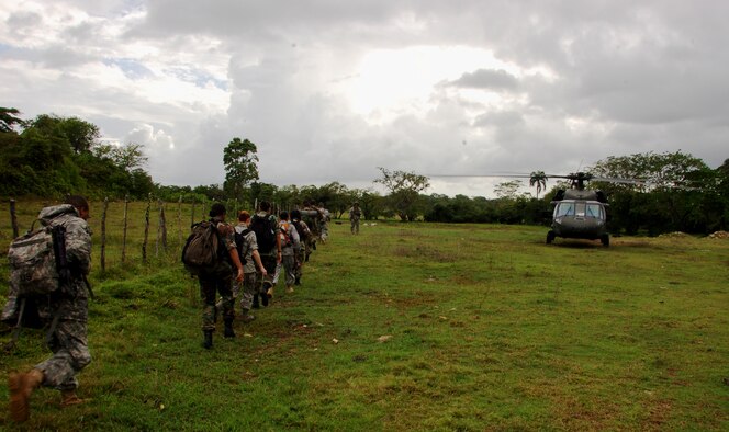 A portion of the Dominican Republic Medical Readiness Training Exercise personnel walk towards an awaiting U.S. Army Blackhawk helicopter, April 28, for transportation past protests, unrelated to the MEDRETE, in towns along the travel route to the final clinic site in Arenoso and billeting in San Francisco de Macorís Arenoso, Dominican Republic, during the largest Maxwell Air Force Base-planned U.S. Air Force Medical Readiness Training Exercise (MEDRETE) to date. A group of 45 medics, translators, security and support personnel derived from the U.S. Air Force, Army and Marines provided dental, dermatologic, general medicine, optometric, pediatric, pharmacy and public health services. The medics treated 8,602 patients at three locations during the eight days of the U.S. SOUTHCOM sponsored Beyond the Horizon 2009 – Caribbean. A MEDRETE is a U. S. Southern command-sponsored exercise designed to provide humanitarian assistance and free medical care to the people of the host nation, while providing an unparalleled training opportunity for U.S. and host nation forces. SOUTHCOM sponsors approximately 70 MEDRETEs per year. (U.S. Air Force Photo by Capt. Ben Sakrisson)