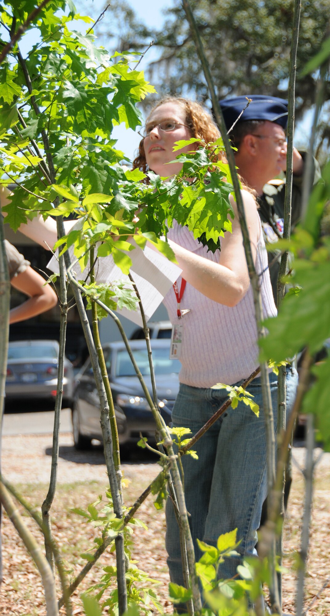 CSC employee Melissa Jones checks out the variety of free trees to be given away at Keesler’s first Great Green Expo in marina park.  (U.S. Air Force photo by Kemberly Groue)