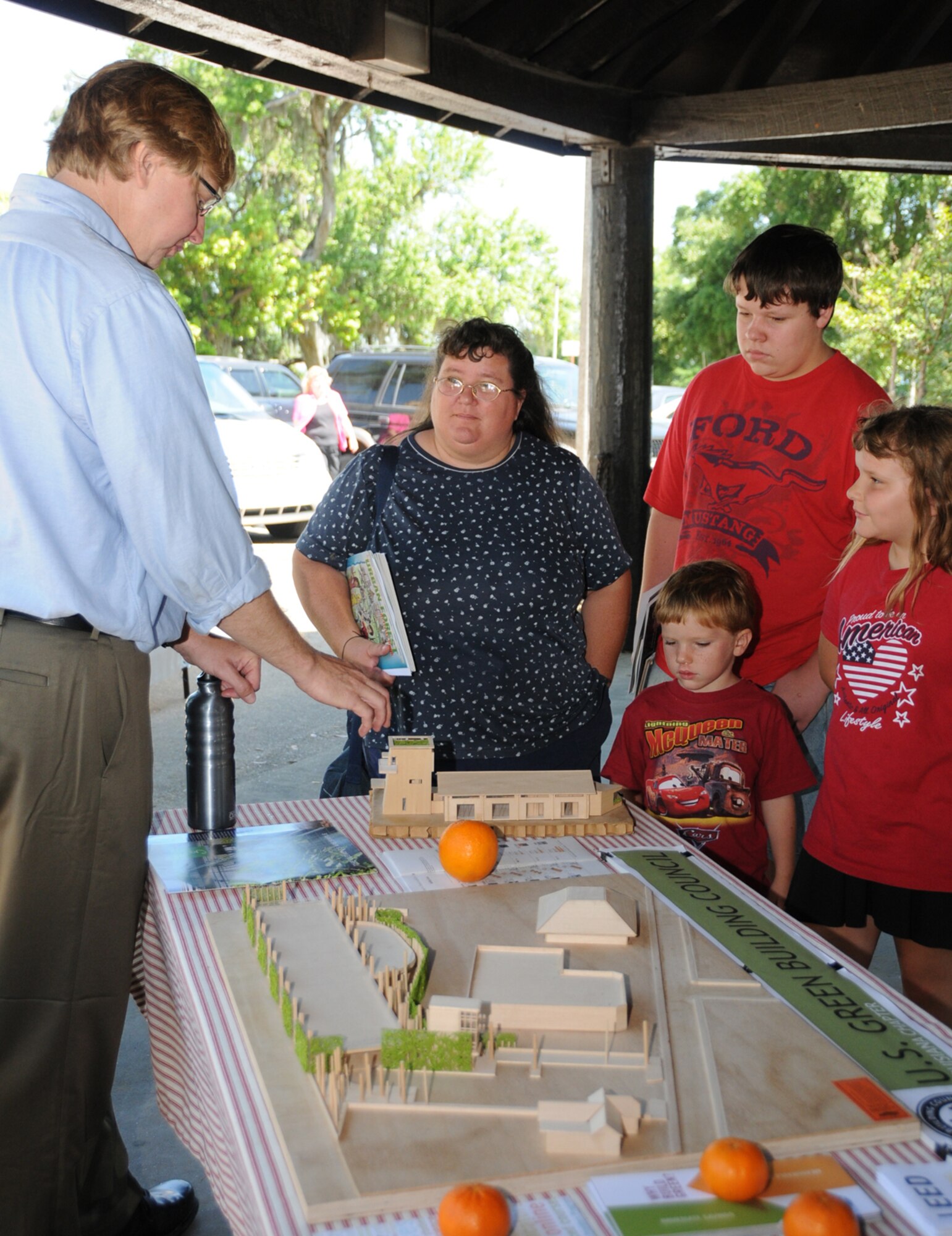 John Anderson, left, briefs Karen Potts and her children, Daniel, 14; Katie, 8; and Johnathan, 4, on building environmentally-friendly structures.  Mrs. Potts is married to Larry Potts, 81st Medical Group.  (U.S. Air Force photo by Kemberly Groue)