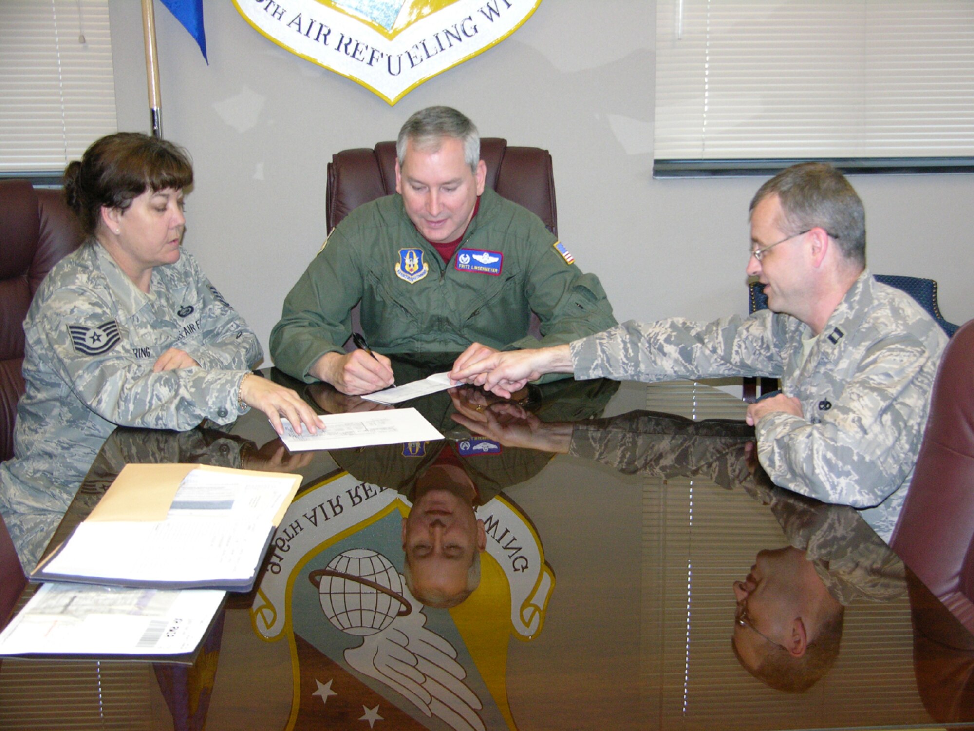 SEYMOUR JOHNSON AIR FORCE BASE, N.C. -- Col. Fritz Linsenmeyer (center), wing commander of the 916th Air Refueling Wing, fills out his pledge card for the Air Force Assistance Fund. This year's pledge drive will end on May 5 so that interested reservists can participate. The goal this year is to raise $4,100 for the wing. Capt. Aaron Beam (right) is the point of contact for the 911th ARS and Tech. Sgt. Sharon Loring is heading up efforts for the 916th (pictured left). The program supports Air Force and component families in need.
