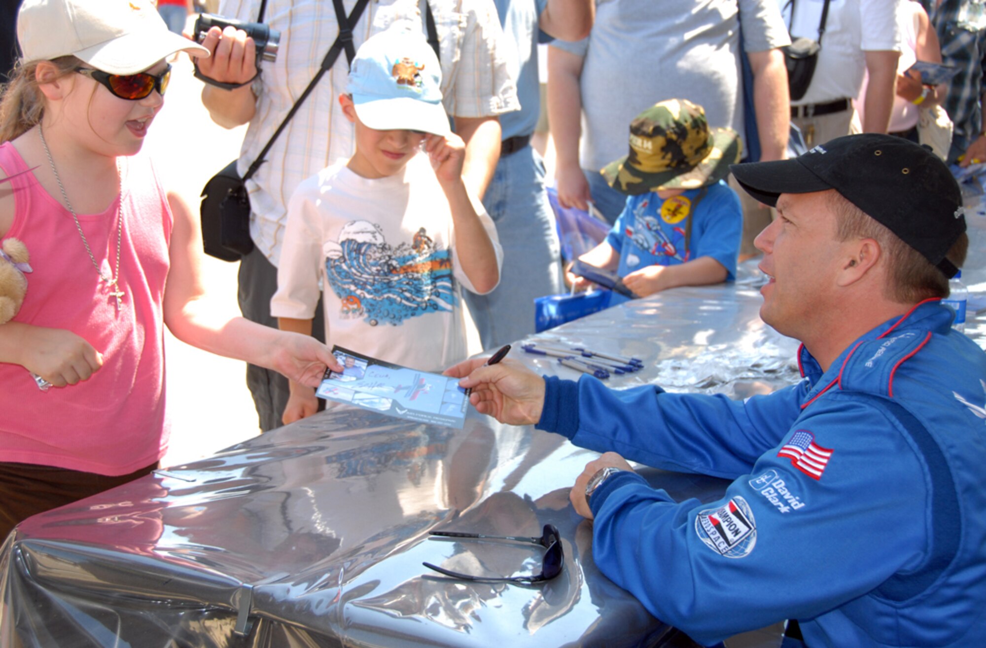 SEYMOUR JOHNSON AIR FORCE BASE, N.C. -- Pilot Ed Hamill signs autographs for young fans during the 2009 Wings Over Wayne Air Show. Hamill pilots the Air Force Reserve stunt plane. U.S. Air Force photo by Tech. Sgt. Gillian Albro