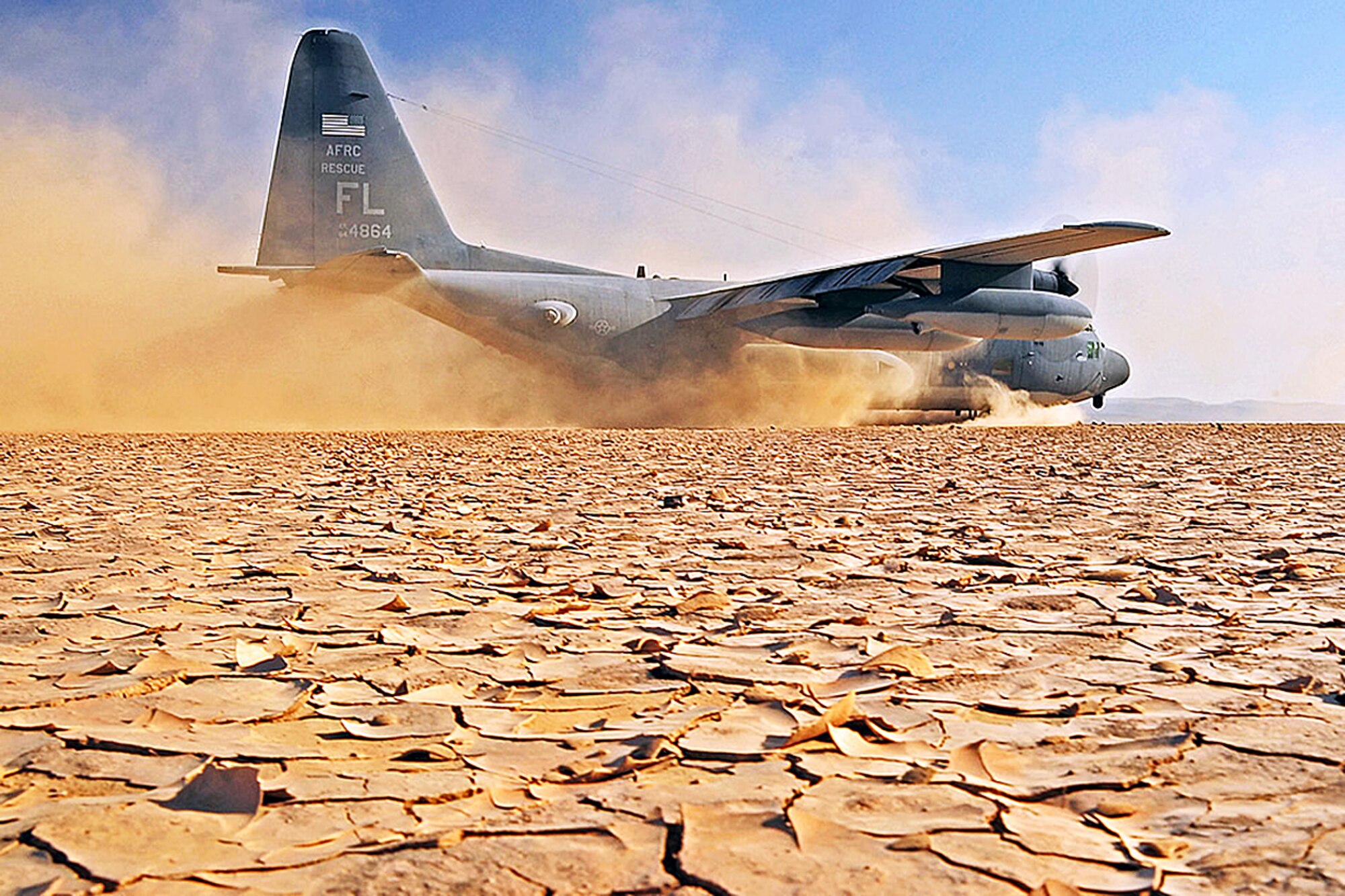 DJIBOUTI, Africa -- An HC-130P/N aircraft from the Air Force Reserve's 920th Rescue Wing, Patrick Air Force BAse, Fla., lands on a dry lake bed during a search and rescue exercise on Grand Bara, Djibouti, April 23, 2009. The air crew, reservists also from the 920th, is assigned to the 81st Rescue Squadron. The exercise consisted of transporting pararescuemen to a water jump, aerial refueling of a CH-53E helicopter, an assault landing on an unimproved runway, and transloading a simulated survivor from the CH-53E. (U.S. Air Force photo/Staff Sgt. Joseph L. Swafford Jr)