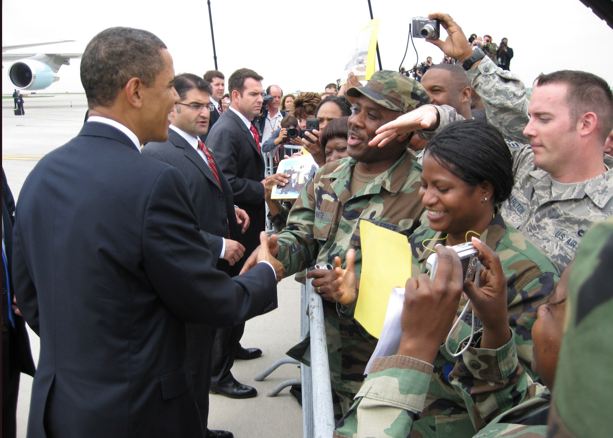 While the media looks on, President Barack Obama greets a member of the 131st Fighter Wing, Missouri Air National Guard, at Lambert-Saint Louis International Airport prior to his departure on Air Force One on April 29.  President Obama marked his 100th day in office with a Town Hall Meeting in Arnold, a surburb of Saint Louis, earlier that day. (U.S. Air Force Photo by Lorenzo "Skip" Doyle)  (RELEASED)