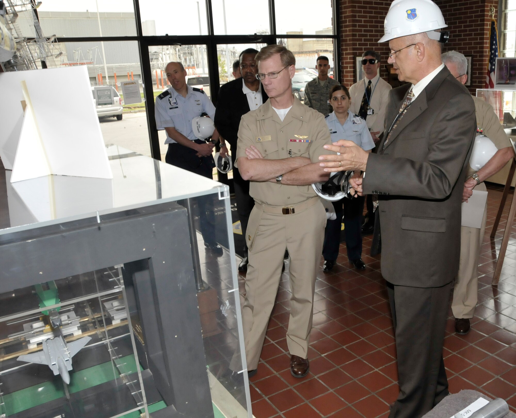 Third from left, Rear Adm. Donald Gaddis, the commander of the Naval Air Warfare Center Aircraft Division and assistant commander for research and engineering of the Naval Air Systems Command, listens as Jack Walters, the deputy director of the 716th Test Squadron, gives an overview of the Propulsion Wind Tunnel facility and the store separation work done on the F/A-18 Hornet and its variants. (Photo by Rick Goodfriend)