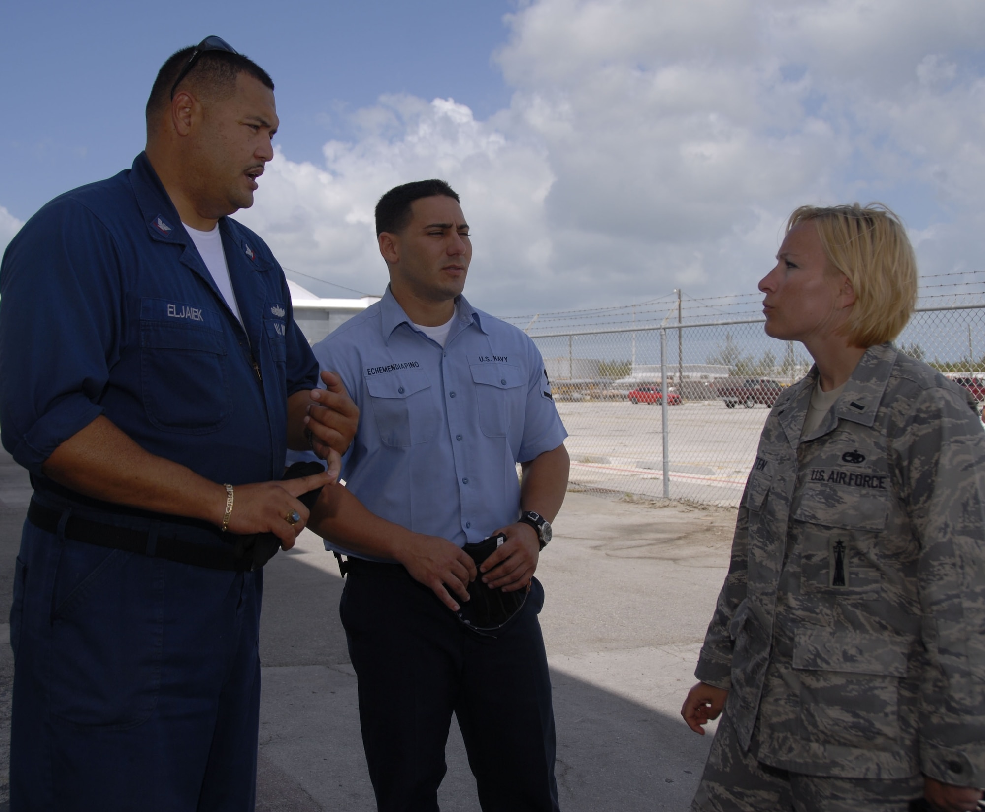 Petty Officers 3rd Class Ernesto Eljaiek and Reynel Echemendiapino, hazardous materials specialists and fleet liaisons at Naval Air Station Key West, Fla., coordinate with 1st Lt. Christy Kasten, 115th Fighter Wing maintenance officer, on hangar logistics as the Airmen prepare to complete their deployment. The Wisconsin Air National Guard's 115th FW was in Florida to participate in air-to-air combat skills training along side their naval counterparts from Strike Fighter Squadron 2, Naval Air Station Lemoore, Calif., during a two-week training exercise. (U.S. Air Force photo/Master Sgt. Dan Richardson) 