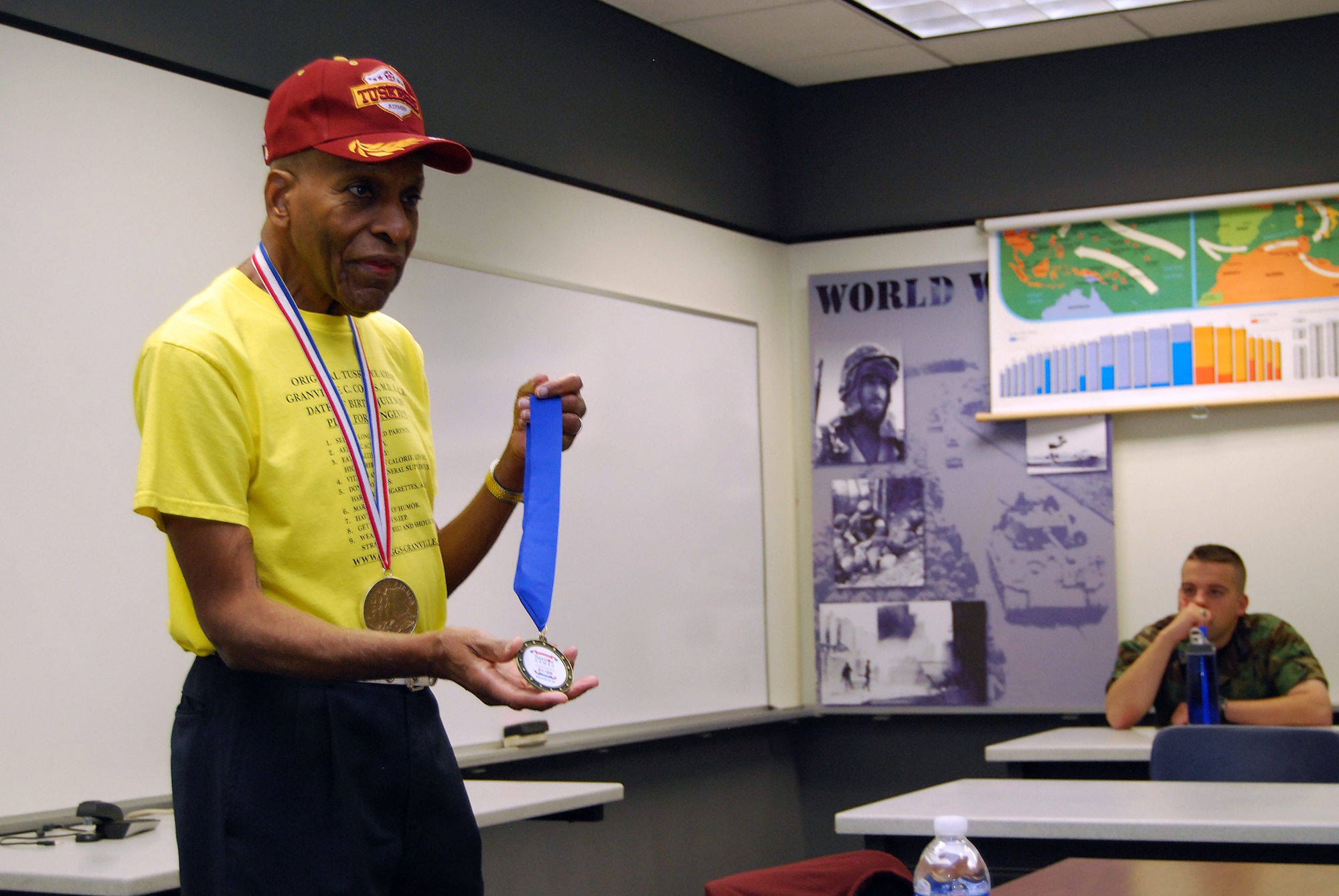 Dr. Granville Coggs shows off a gold medal he won for the 400-meter run during the 2009 San Antonio Senior Games during a World War II history class at the U.S. Air Force Academy, Colo., April 24. Dr. Coggs, one of the original Tuskegee Airmen, also wore the Congressional Gold Medal bestowed to all Tuskegee Airmen in a March 2007 ceremony. (U.S. Air Force photo/Staff Sgt. Don Branum)