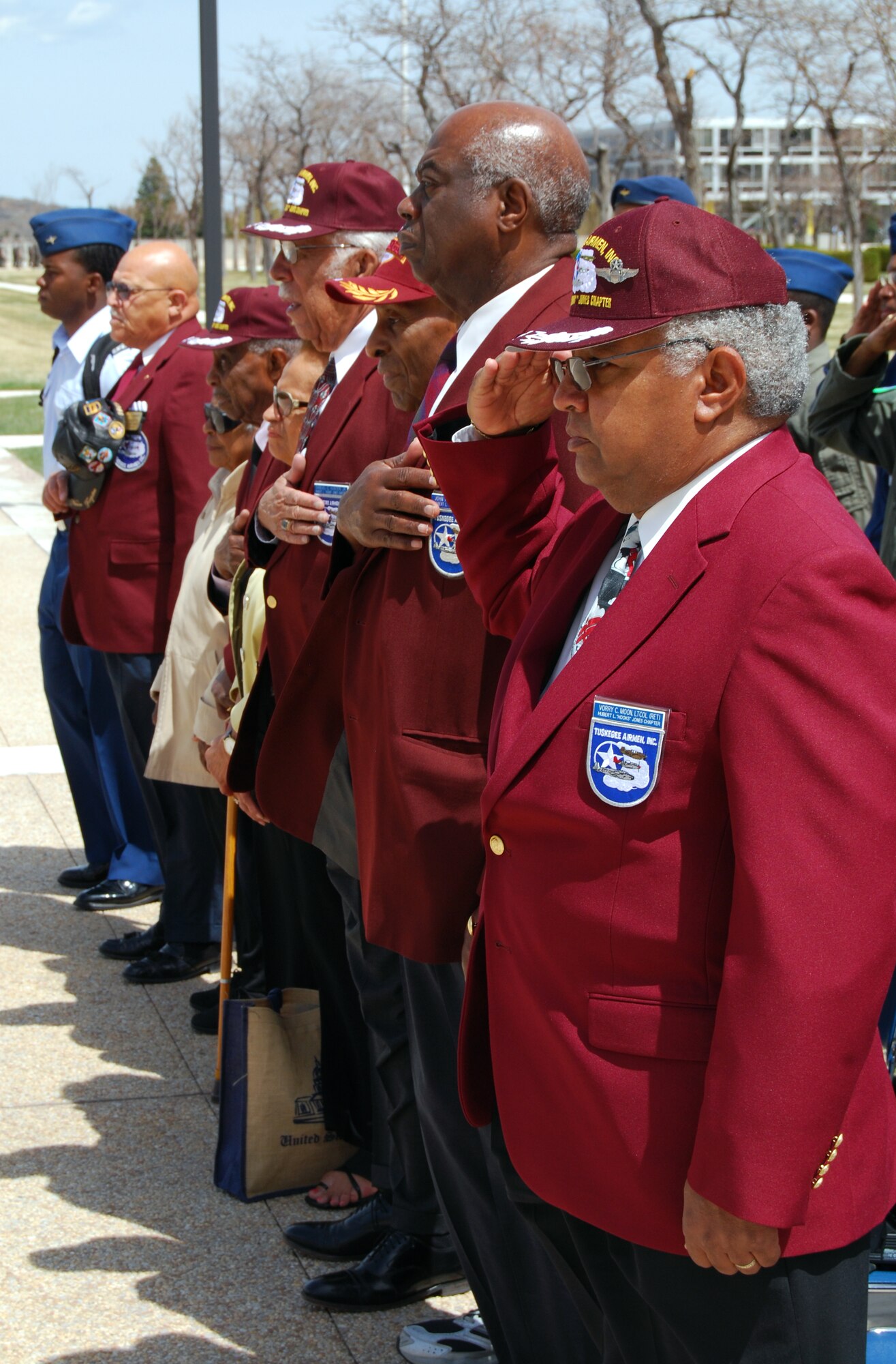 Tuskegee Airmen pay honors to the American flag during U.S. Air Force Academy cadets' noon formation at the Academy in Colorado Springs, Colo. The Academy's History Department invites the Tuskegee Airmen annually to share their history and experiences with cadets. (U.S. Air Force photo/Staff Sgt. Don Branum)