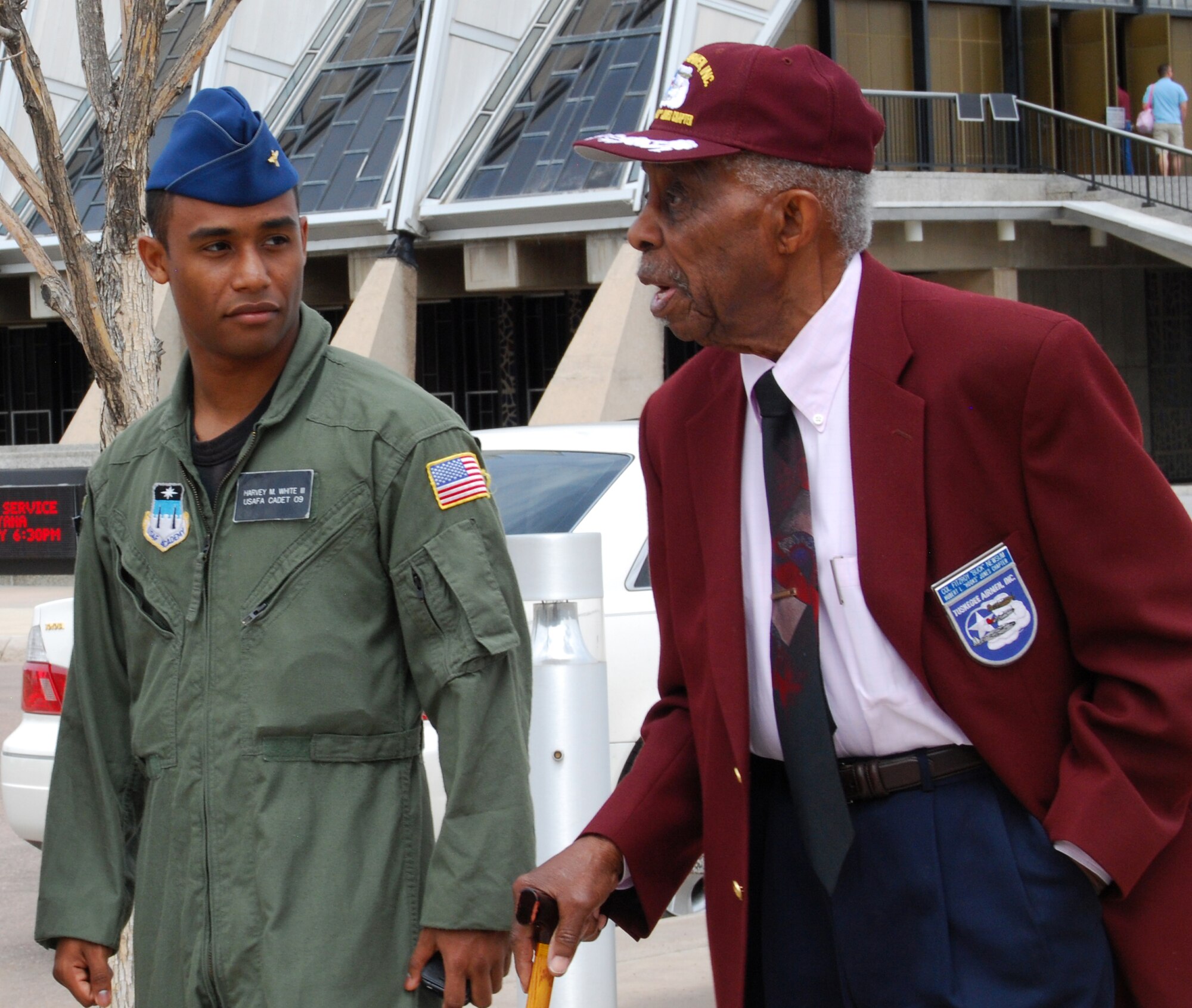 U.S. Air Force Academy Cadet 1st Class Harvey White III escorts retired Col. Fitzroy "Buck" Newsum, shown here, and other Tuskegee Airmen during their visit to the Academy in Colorado Springs, Colo., April 24. Cadet White, a senior assigned to Cadet Squadron 20, previously escorted Tuskegee Airmen during a 2007 visit. (U.S. Air Force photo/Staff Sgt. Don Branum)