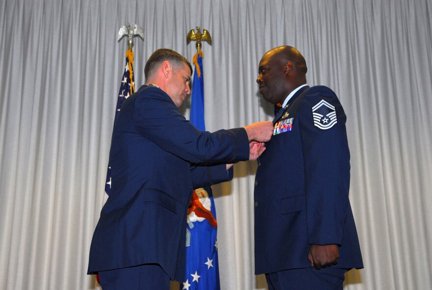 Col.Jose Rivera (left), 5th Combat Communications Squadron commander, pins the Bronze Star medal on Senior Master Sgt.Bobby Simmons Jr. in a ceremony April 23. 
U.S. Air Force photo by Tommie Horton
