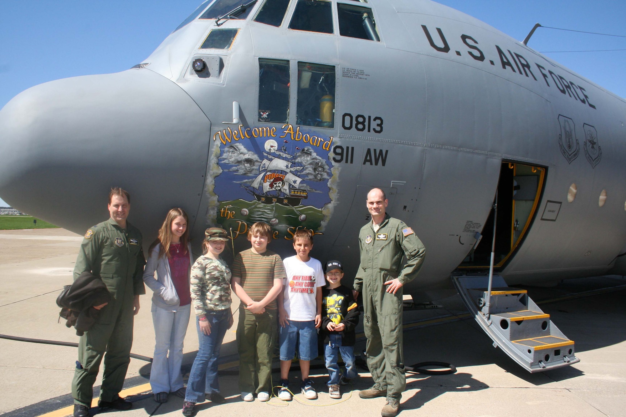 Lt. Col. Aldo Filoni, Chief of Operations Plans, 911th Operations Support Flight and Lt. Col. William Gutermuth, Chief of Safety, 911th Airlift Wing pose for a photo after escorting children of 911th AW staff members onto a C-130 Hercules. The tour of the aircraft was part of the national Take Your Child to Work Day. (photo by Staff. Sgt Roberto Modelo)