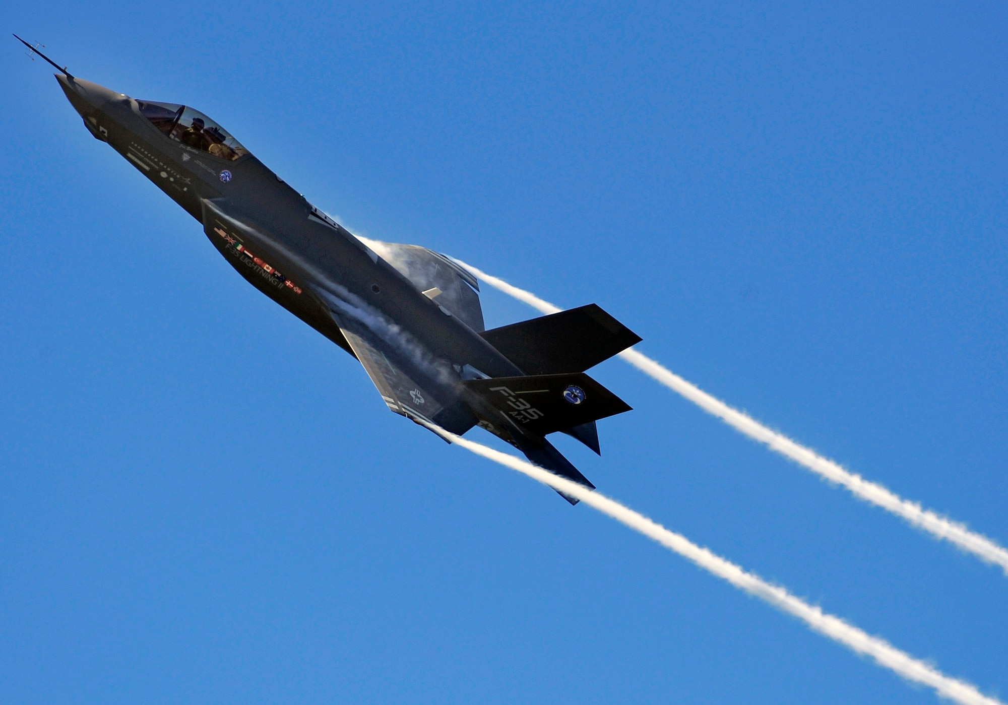 An F-35 Lightning II Joint Strike Fighter test aircraft banks over the flightline at Eglin Air Force Base, Fla., April 23, sending contrails streaming off the wings.  The aircraft is the first F-35 to visit the base which will be the future home of the JSF training facility.  (U.S. Air Force photo/Senior Airman Julianne Showalter)