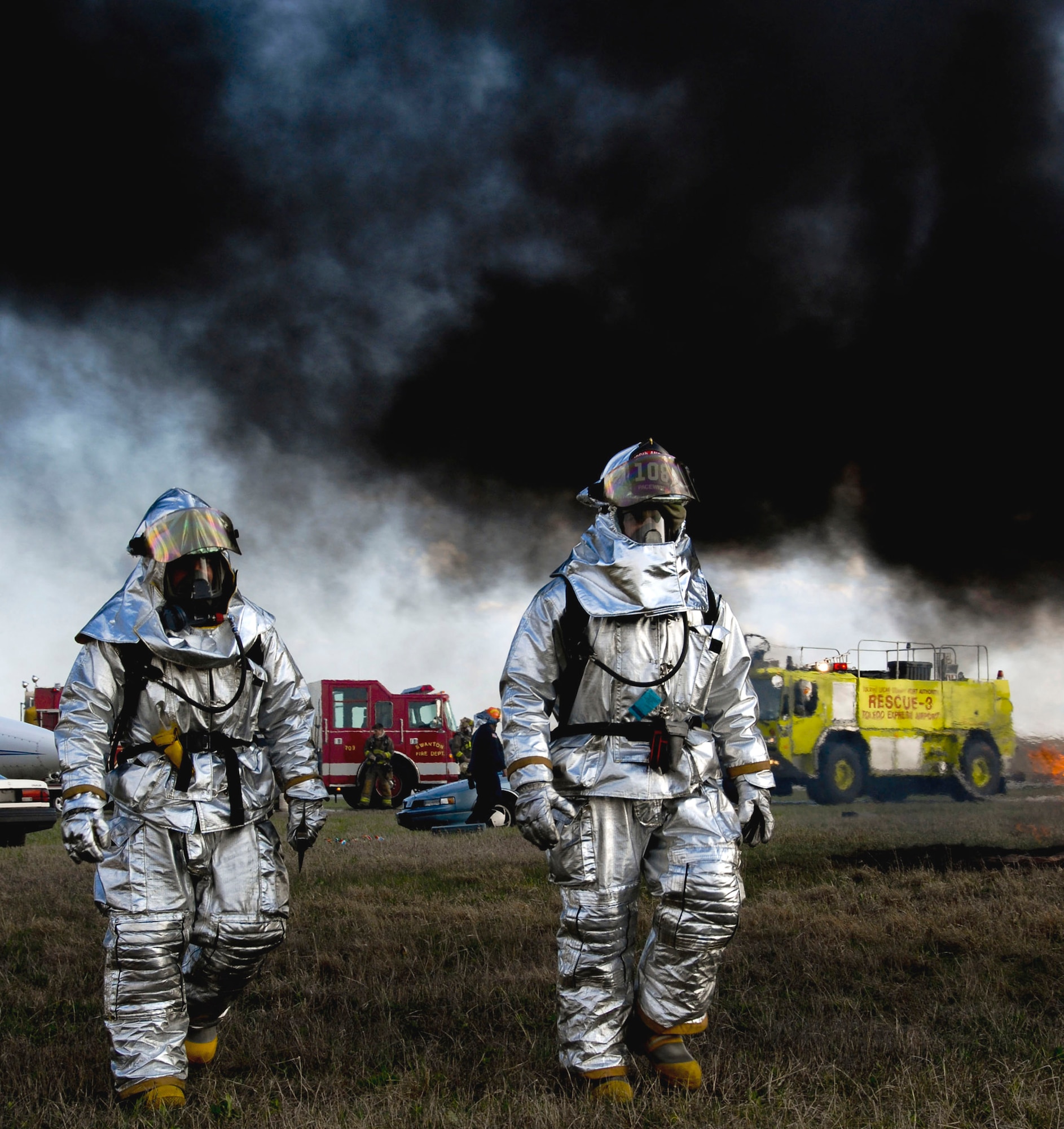 Two firefighters from the Ohio Air National Guard's 180th Fighter Wing fire department participate in an aircraft crash and recovery exercise April 22 at the Toledo Express Airport.  The drill tests the response of local emergency, fire and rescue crews that normally would respond to such an incident.  (U.S. Air Force photo/Tech. Sgt. Beth Holliker)