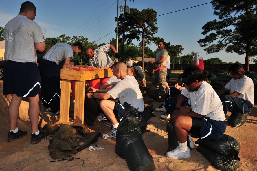 Shaw Air Force Base, S.C.- Members of Shaw AFB shovel mounds of dirt making hundreds of sandbags,  April 30, 2009.  The sandbags will be used in the upcoming ORE/ORI, supporting needs such as simulated bunkers and weights for shelters and contamination covers.  (U.S. Air Force Photo by Senior Airman William Coleman)